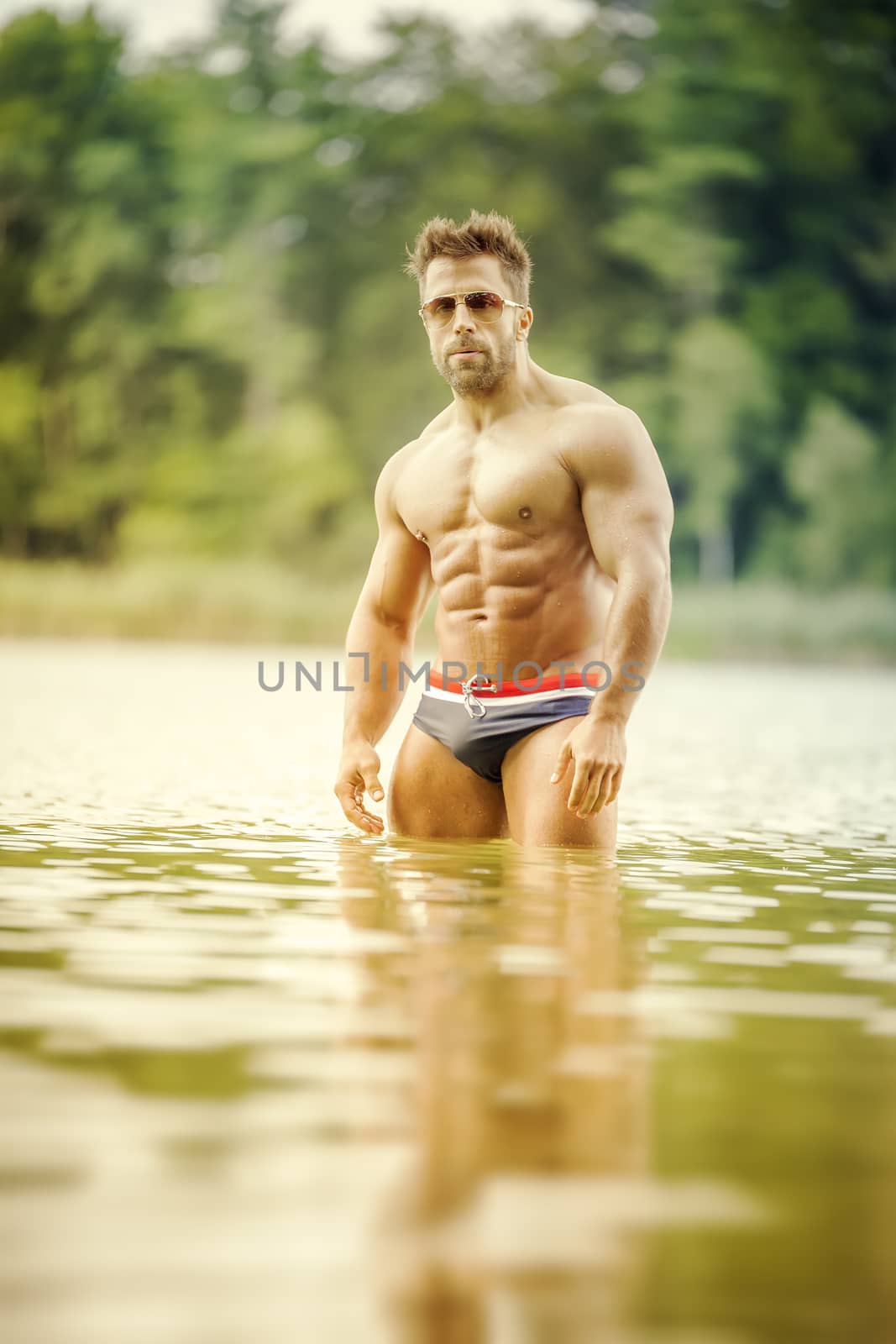 muscular man lake by magann