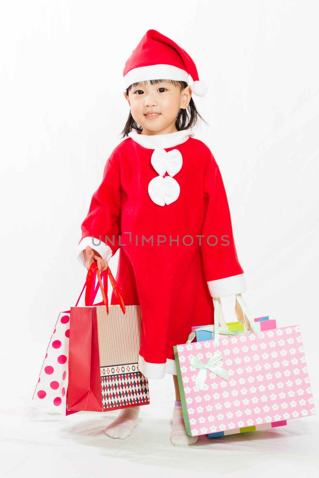 Asian Little Santa Claus with shopping bag in white isolated backgroundll