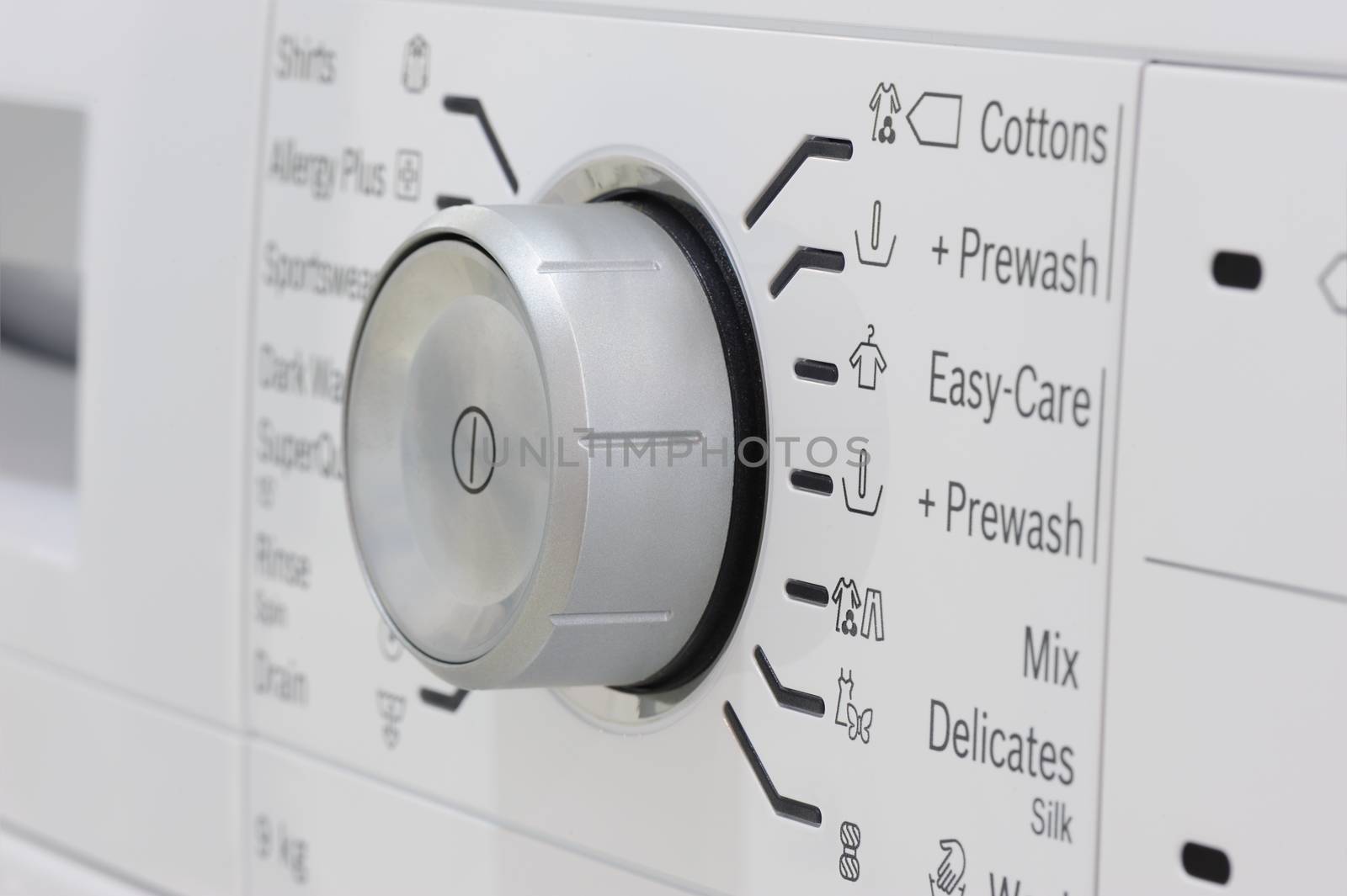 closeup of new white laundry or washing machine, selective focus on control elements