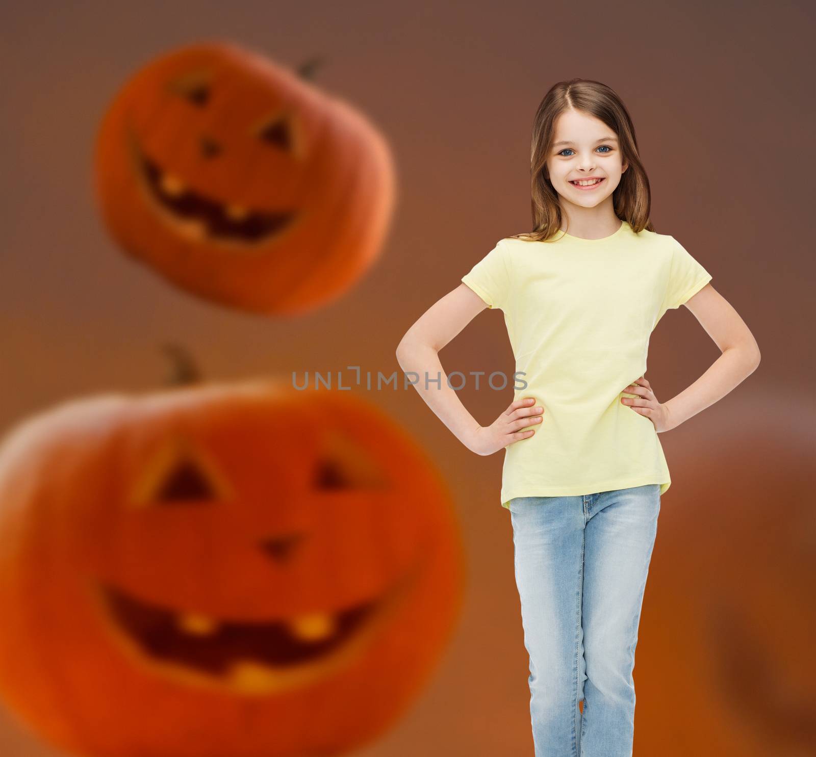 smiling girl over pumpkins background by dolgachov