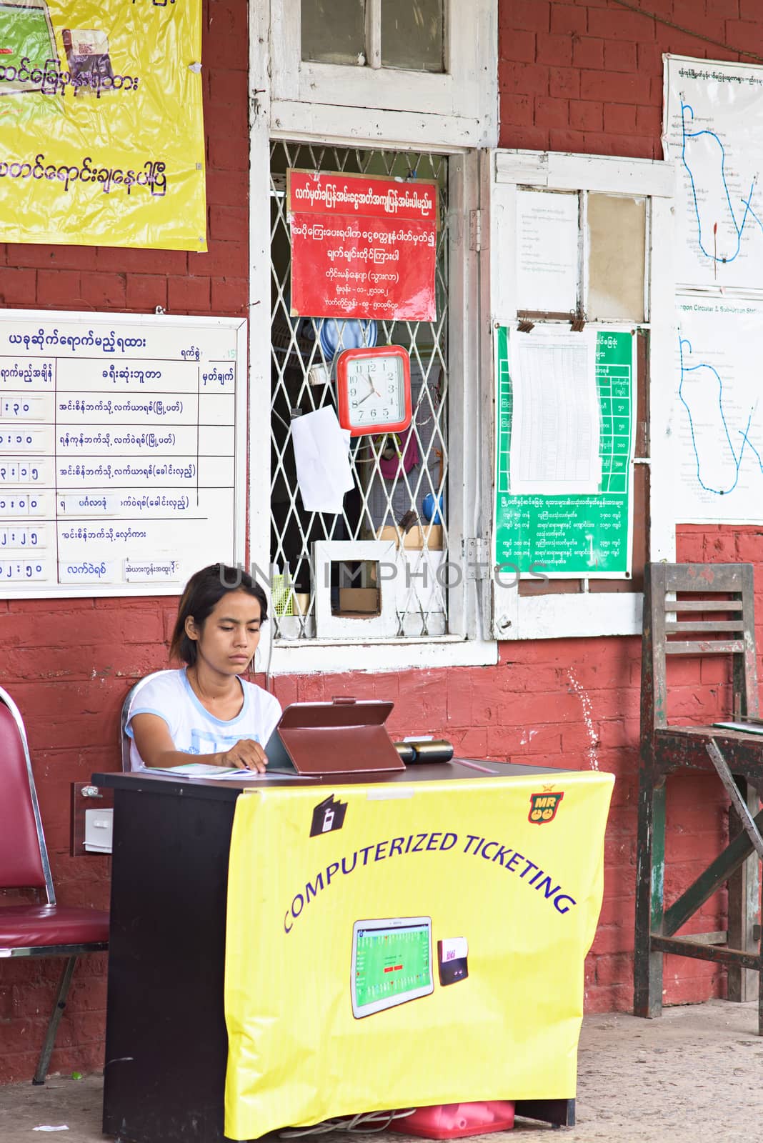 Yangon, Myanmar - July 5, 2015: Myanmar’s old fashioned but popular railway system has introduced computerized ticketing in Yangon, utilizing tablet computers to issue tickets.
