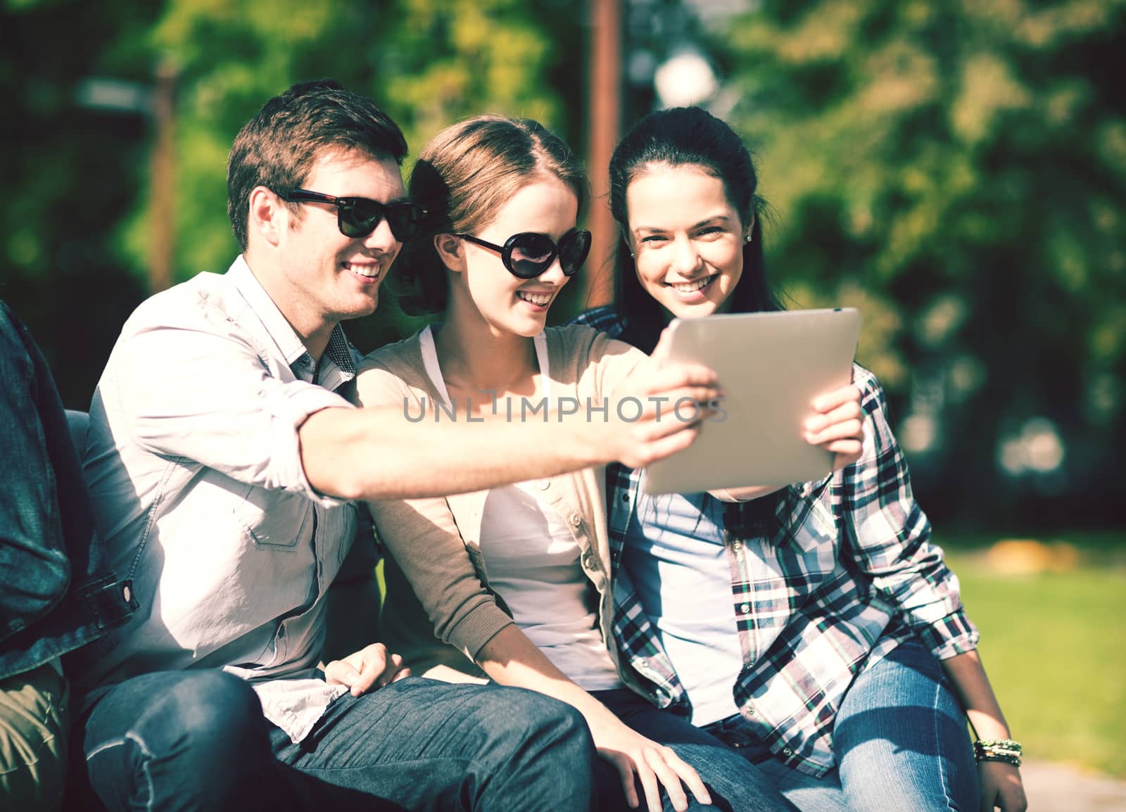 teenagers taking photo outside by dolgachov