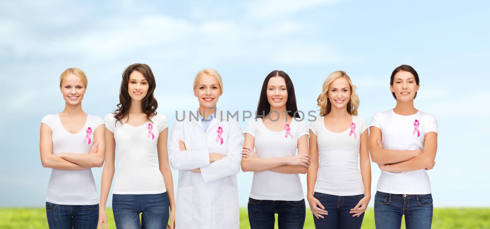 smiling women with pink cancer awareness ribbons by dolgachov