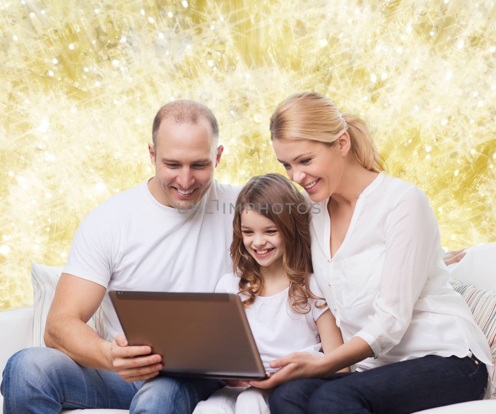 smiling family with laptop by dolgachov