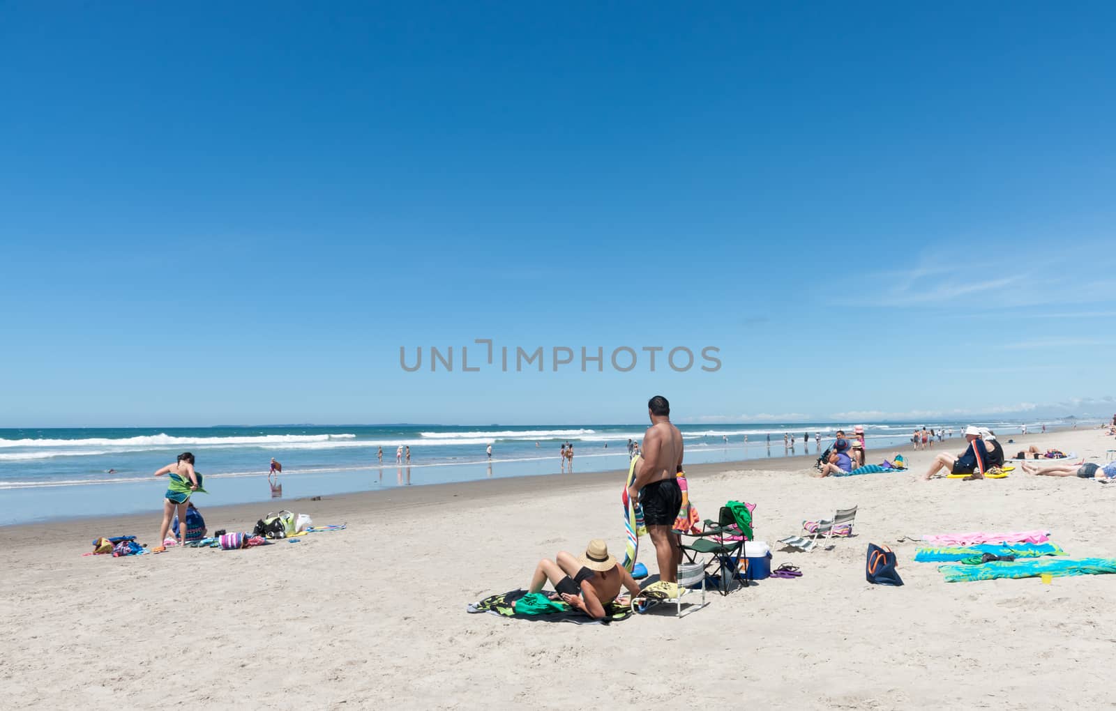 People enjoying a summer day at beach Omanu Tauranga New Zealand.