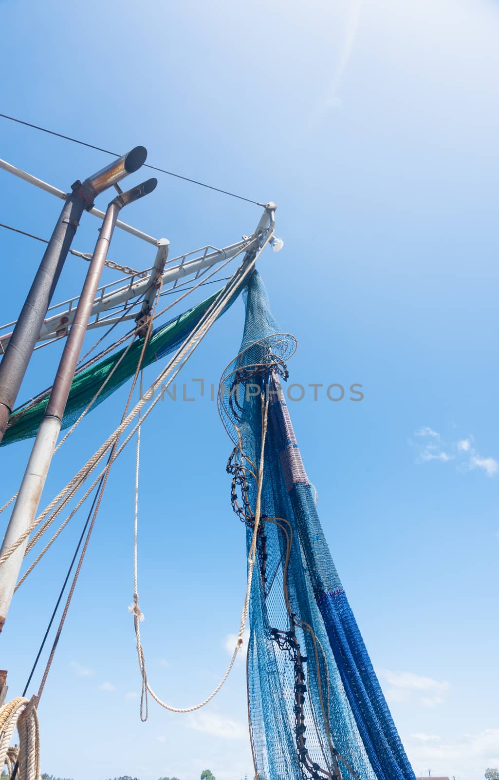 Fishing nets hanging from boats mast  drying in sun at Yamba, Queensland Australia.