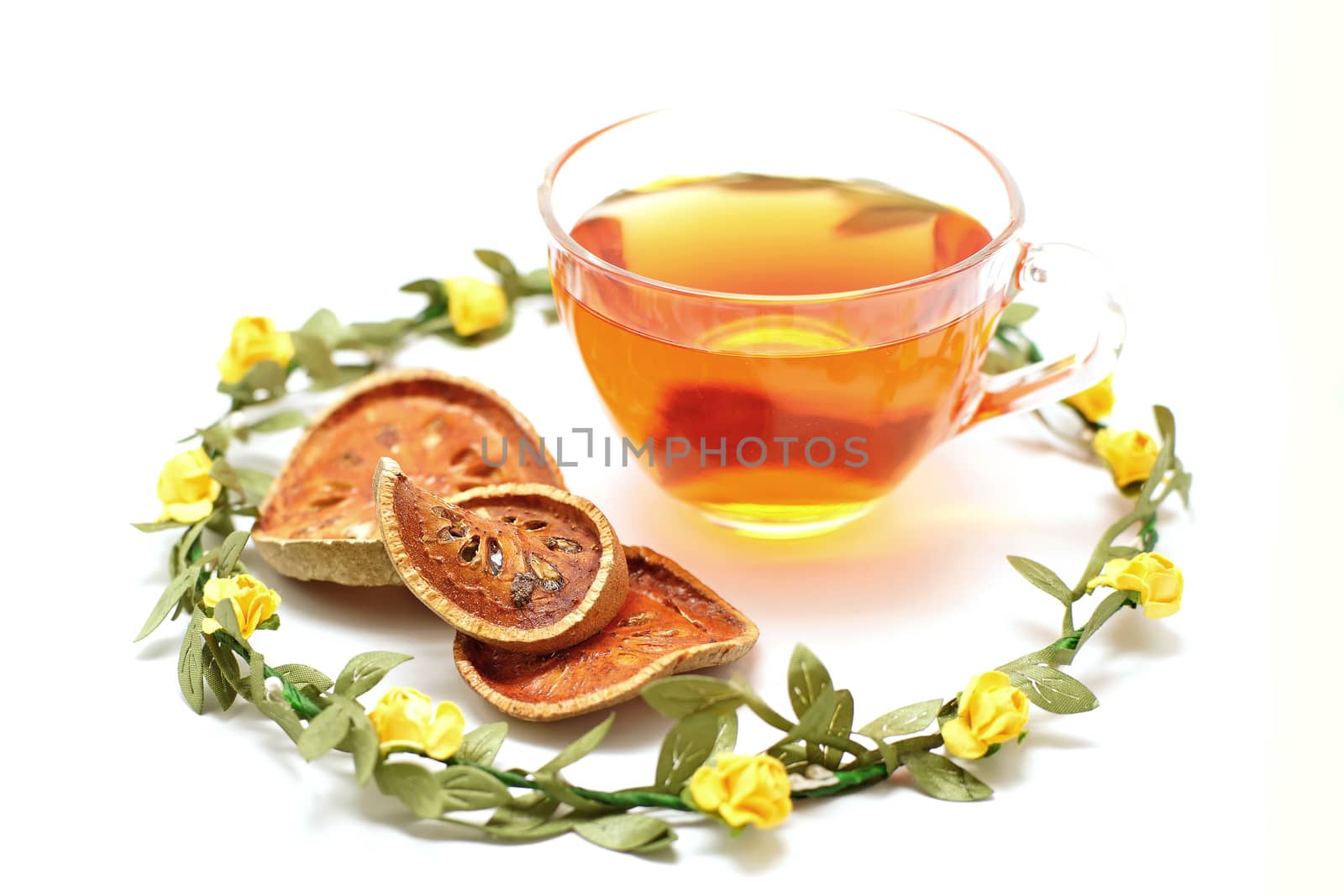hot bael juice and dried bael fruit isolated on white background