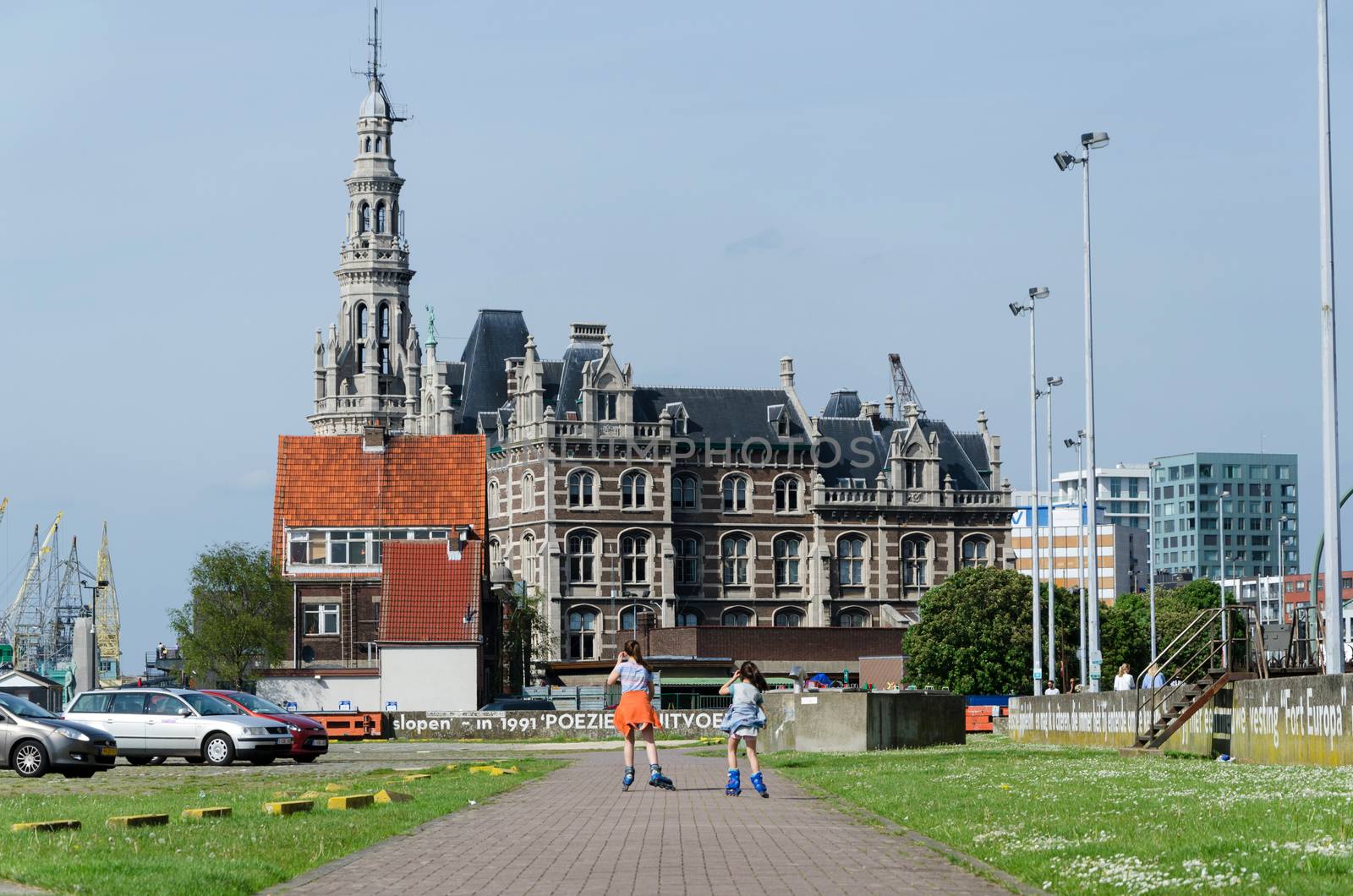 Antwerp, Belgium - May 11, 2015: Children roller skating against pilotage building in Antwerp, Belgium. It is the most populous city in Belgium with a population of 510,610.