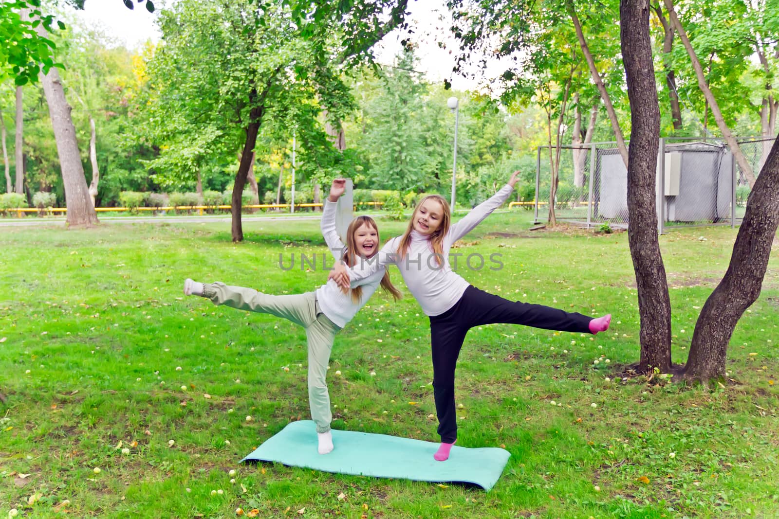 Photo of two playing girls in summer