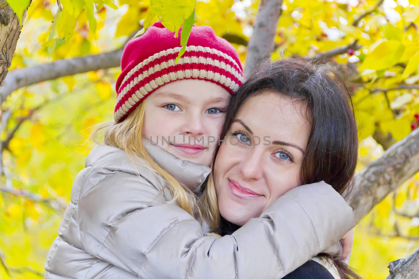 Portrait of happy mother and daughter in autumn