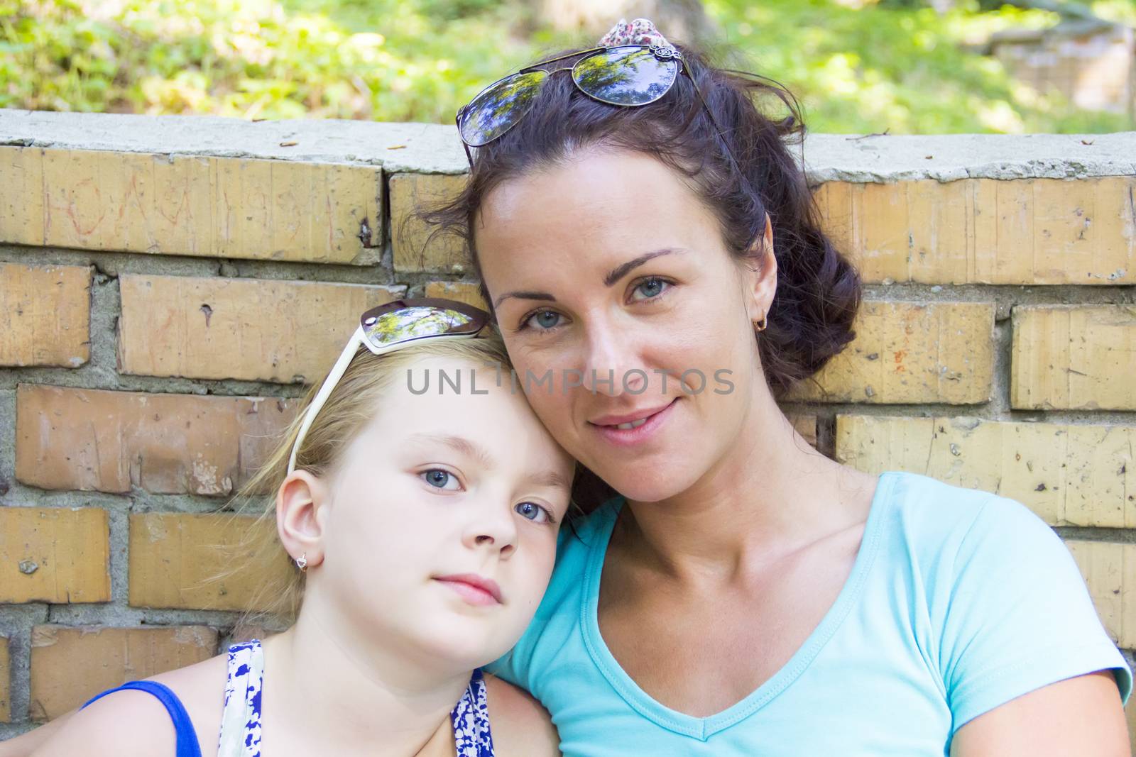 Photo of mother and daughter in summer with sunglass