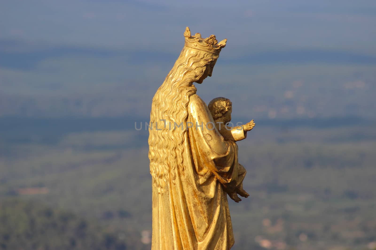 Golden statue of Virgin Mary and Baby Jesus on the roof of a church. Le Val, Provence-Alpes-Côte d'Azur in France