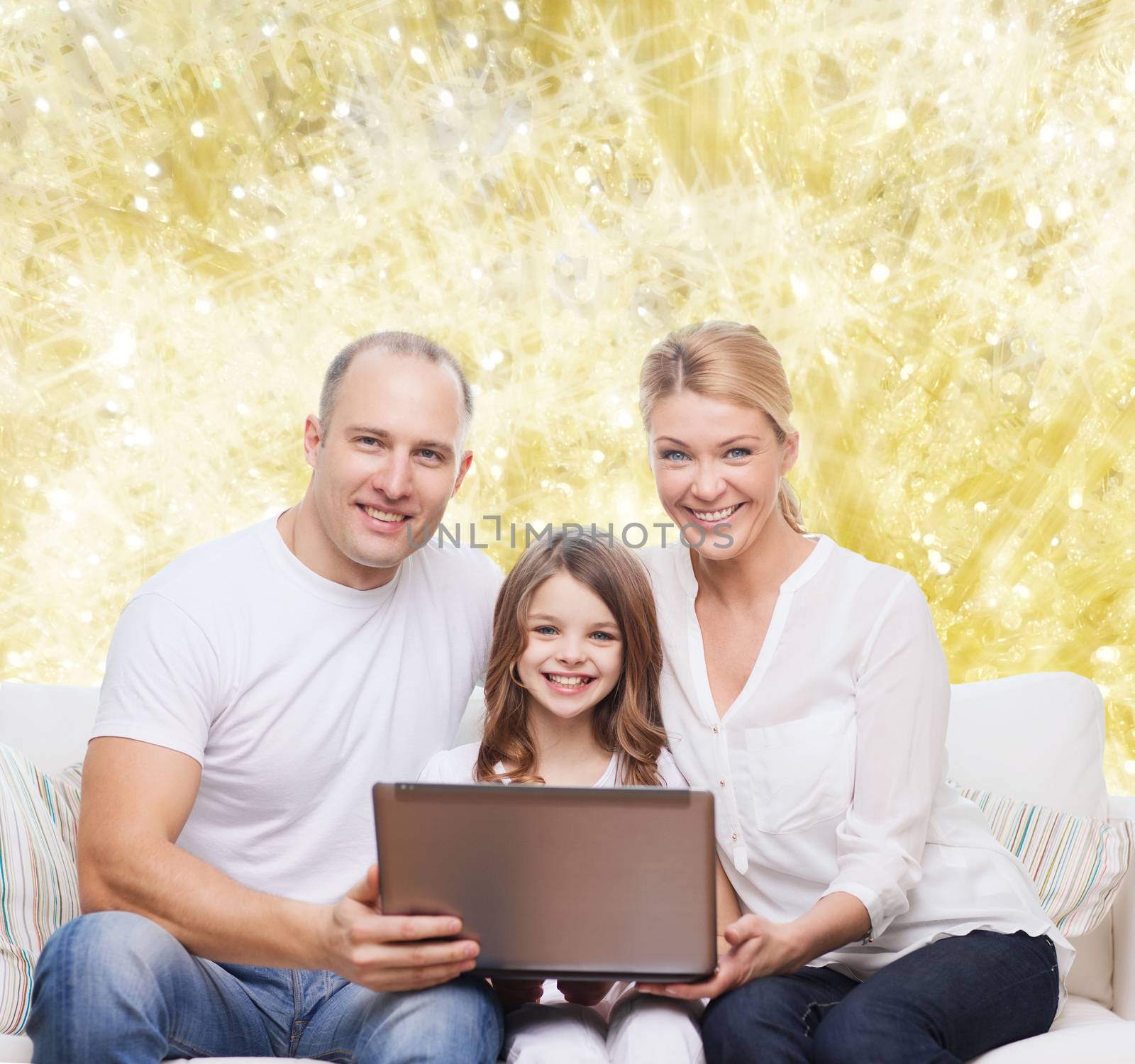 smiling family with laptop by dolgachov