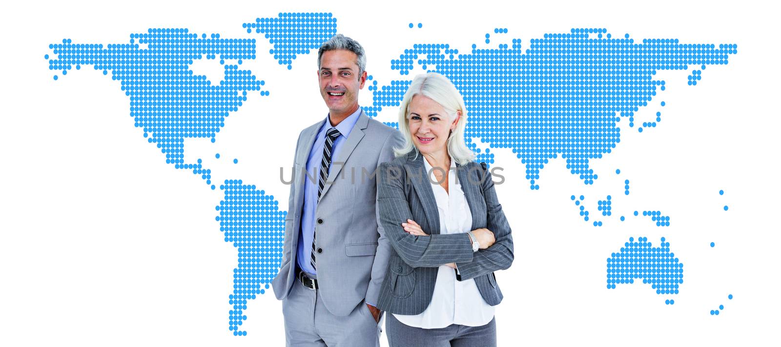  Smiling businesswoman and man with arms crossed against blue world map