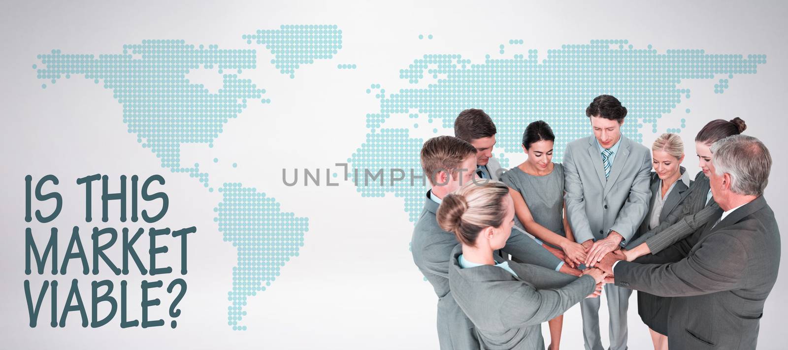 Smiling business team standing in circle hands together against green world map on white background