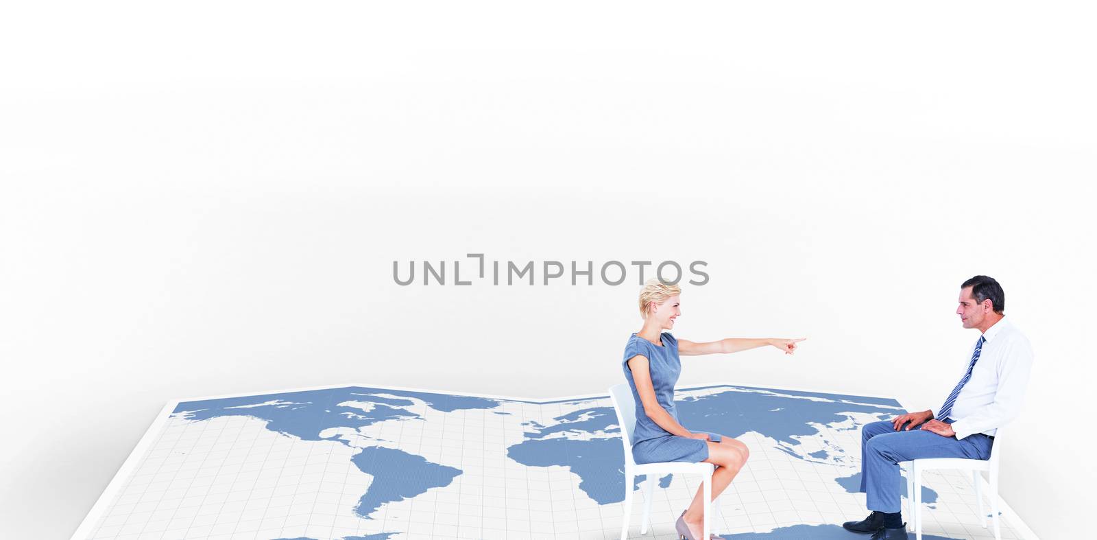 businesswoman pointing at businessman against world map