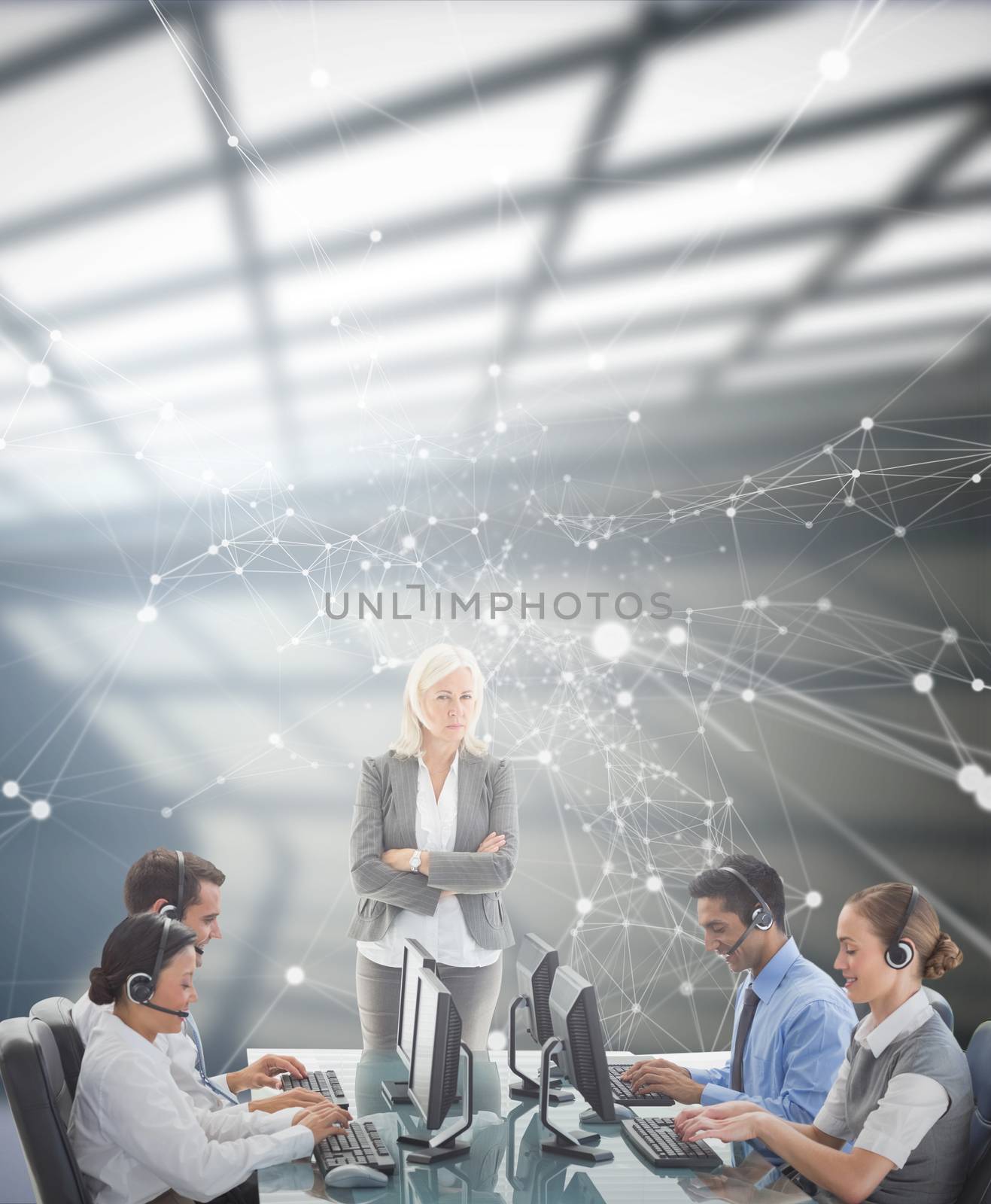 Unhappy businesswoman monitoring her colleagues  against white room with windows at ceiling