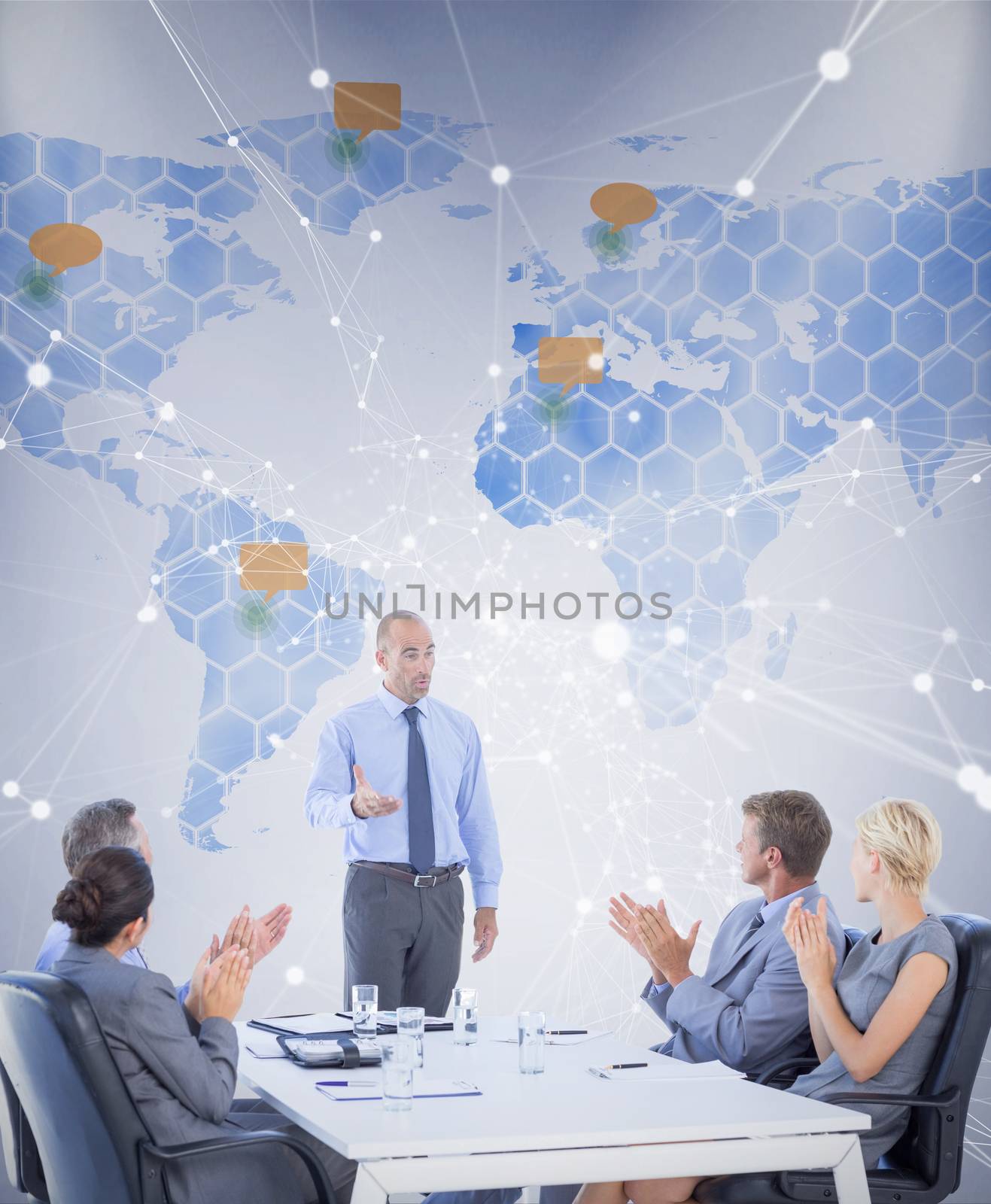 Business people applauding during meeting  against world map 