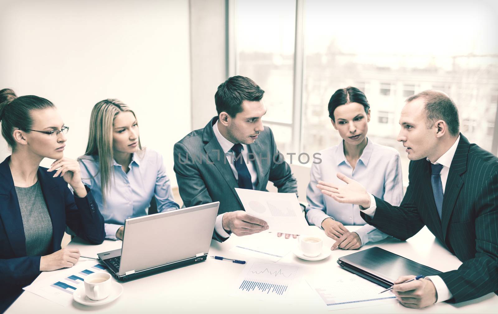 business team with laptop having discussion by dolgachov