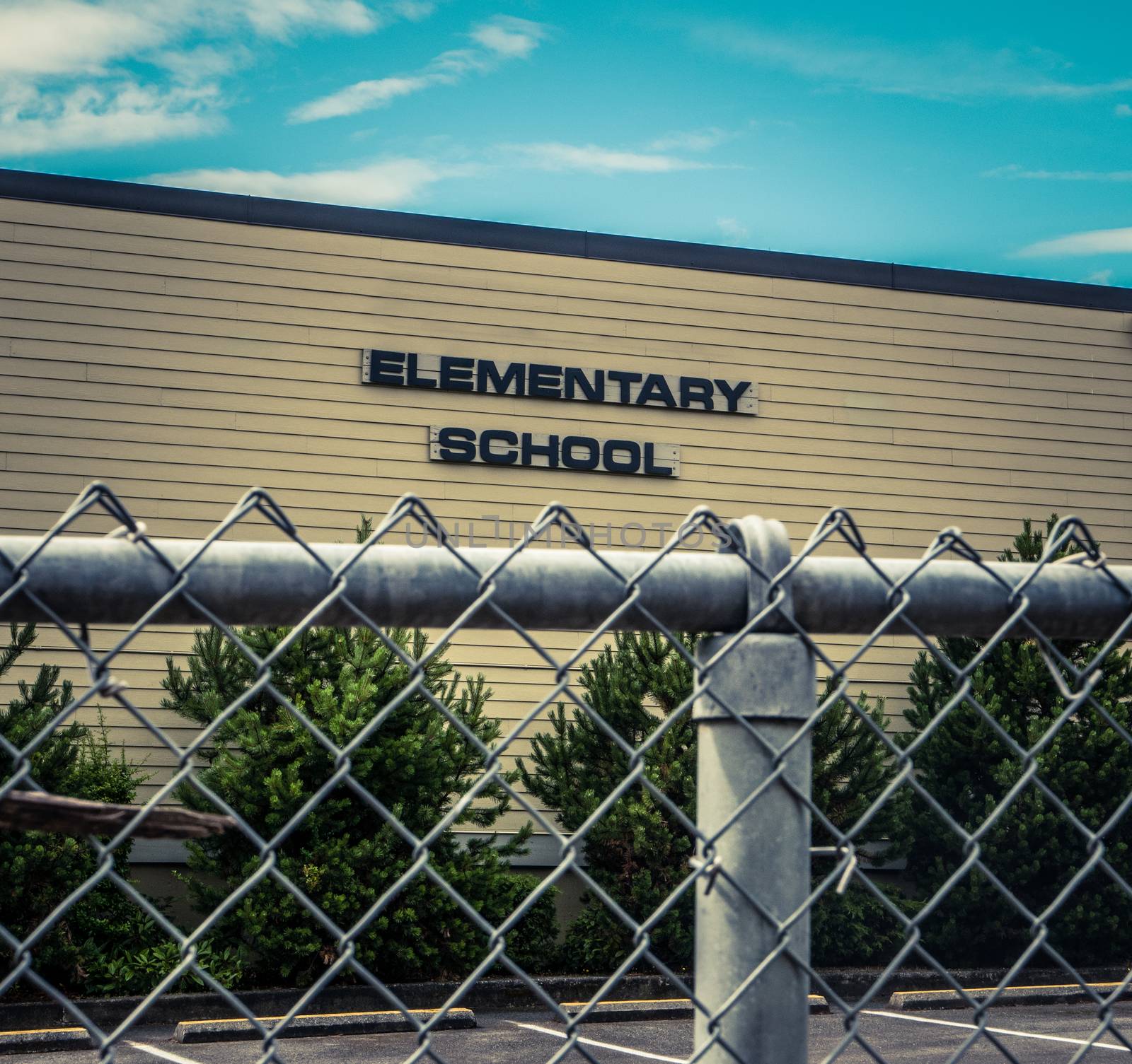 Typical USA Elementary School With Chain Link Fence In Foreground