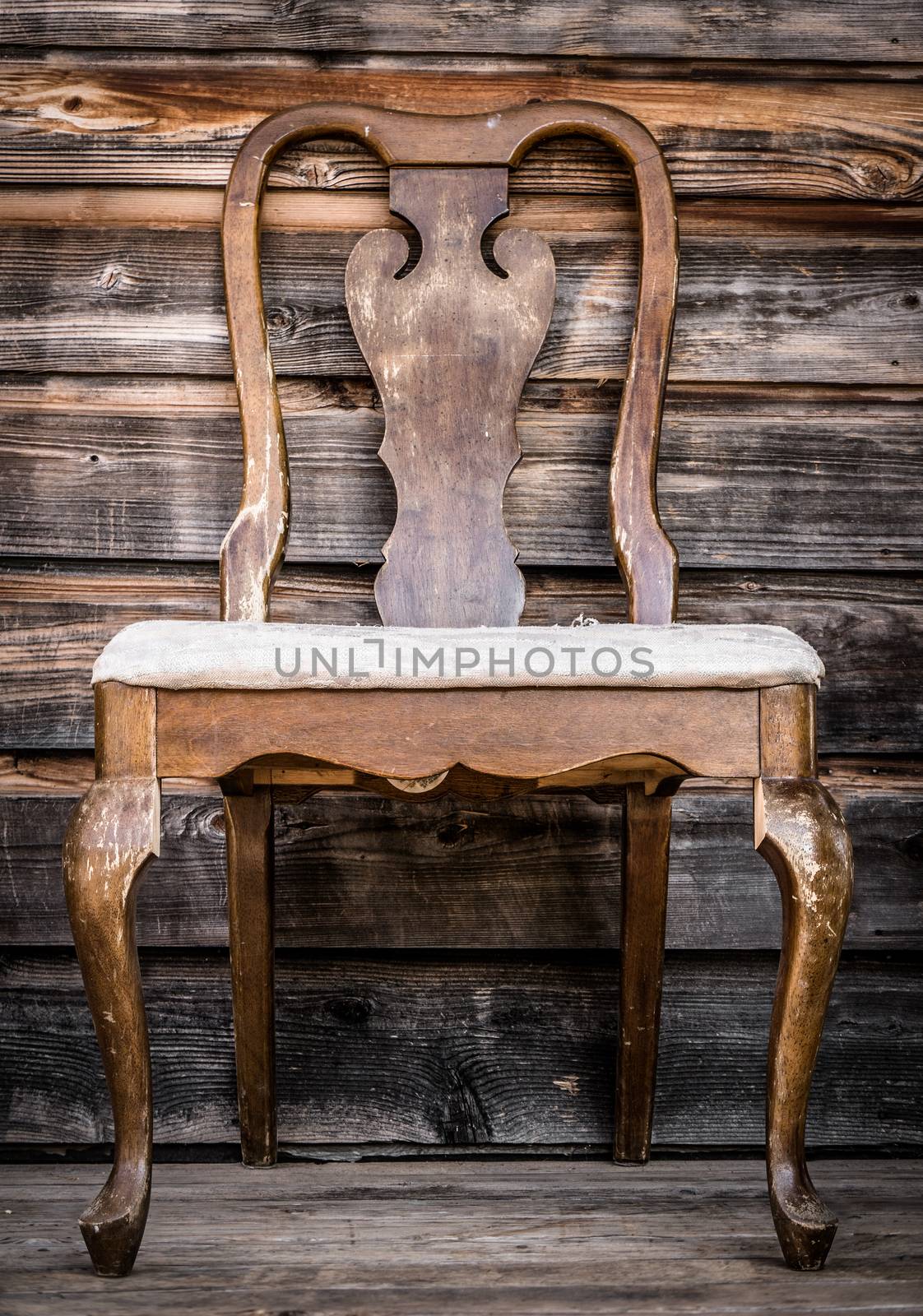 Old Rustic Wooden Chair On Farmyard Porch