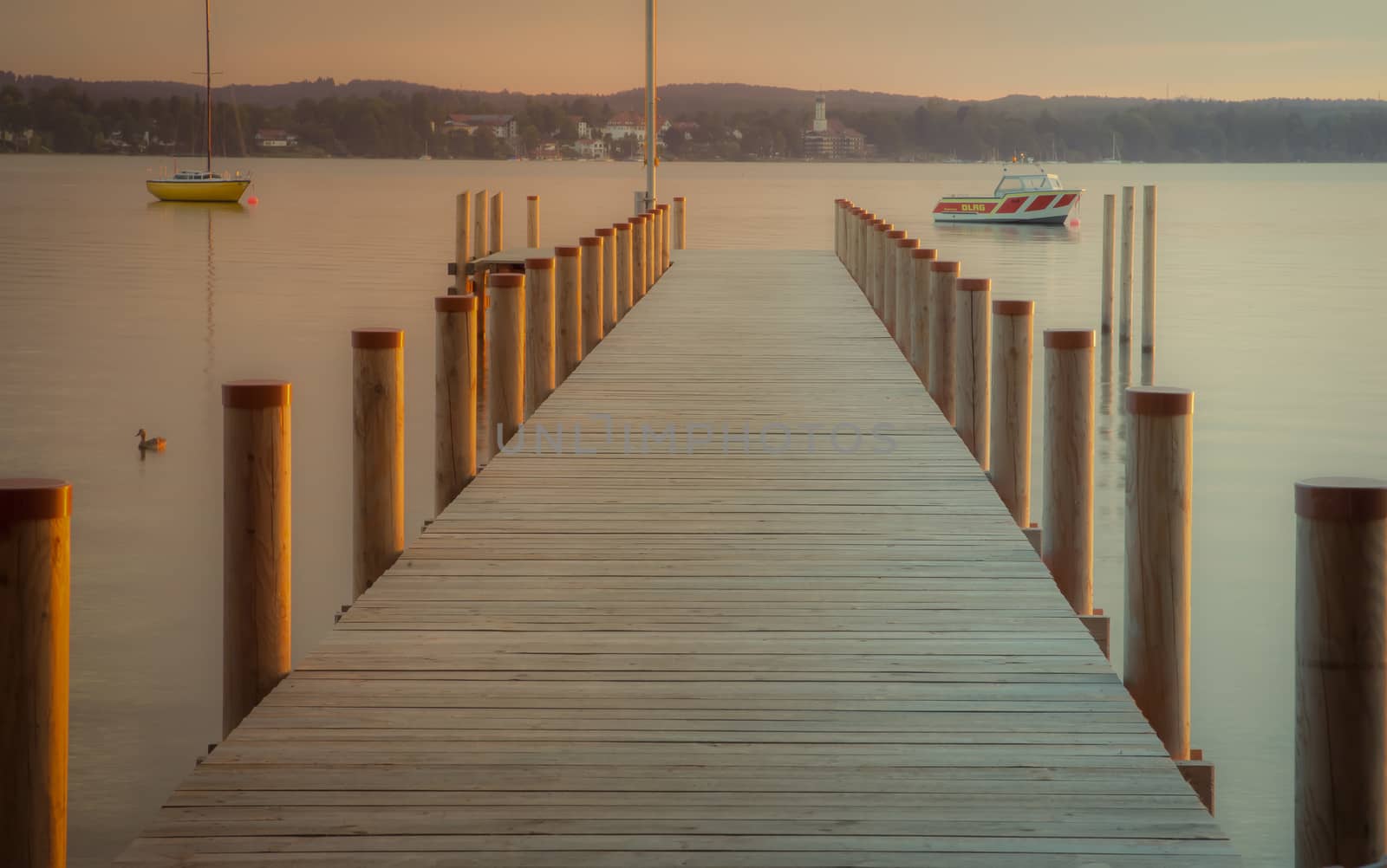 Reflections and jetty at Lake Starnberg  in the evening light