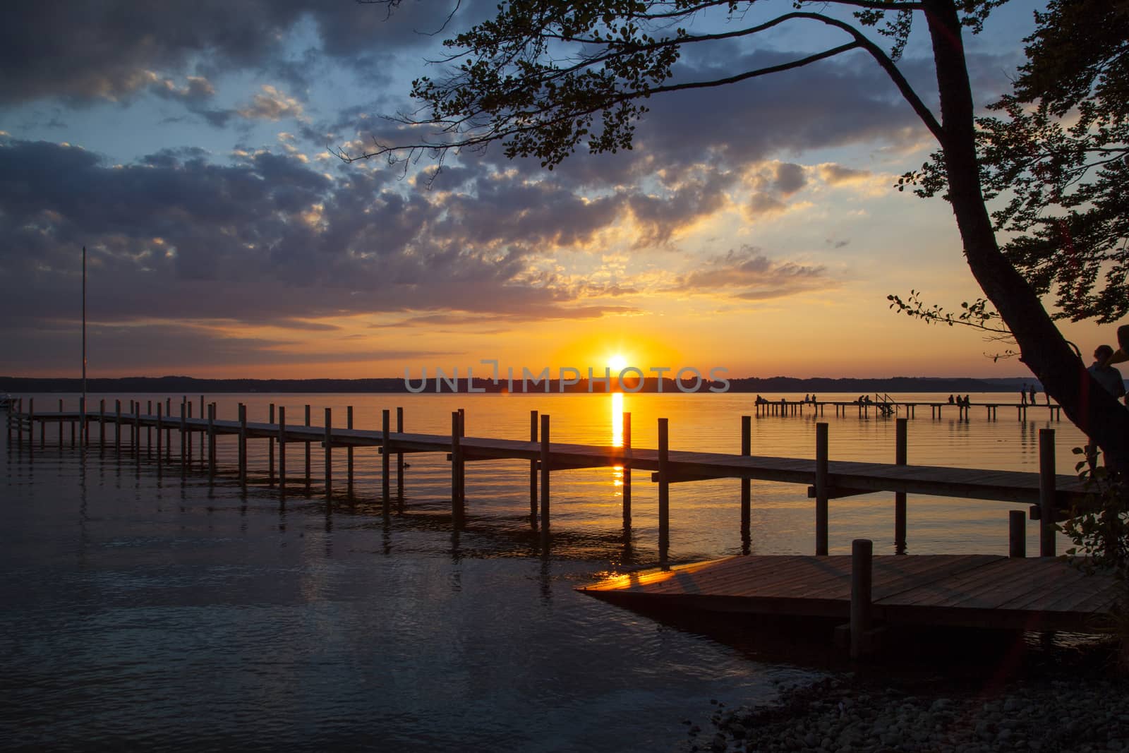 Reflections and jetty at Lake Starnberg  in the evening light