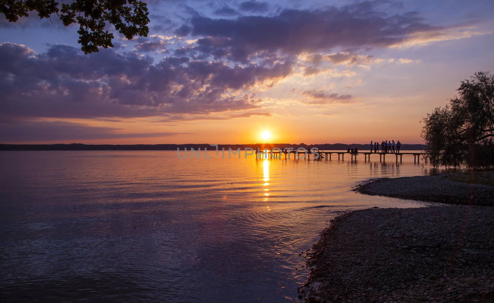 Reflections and jetty at Lake Starnberg  in the evening light