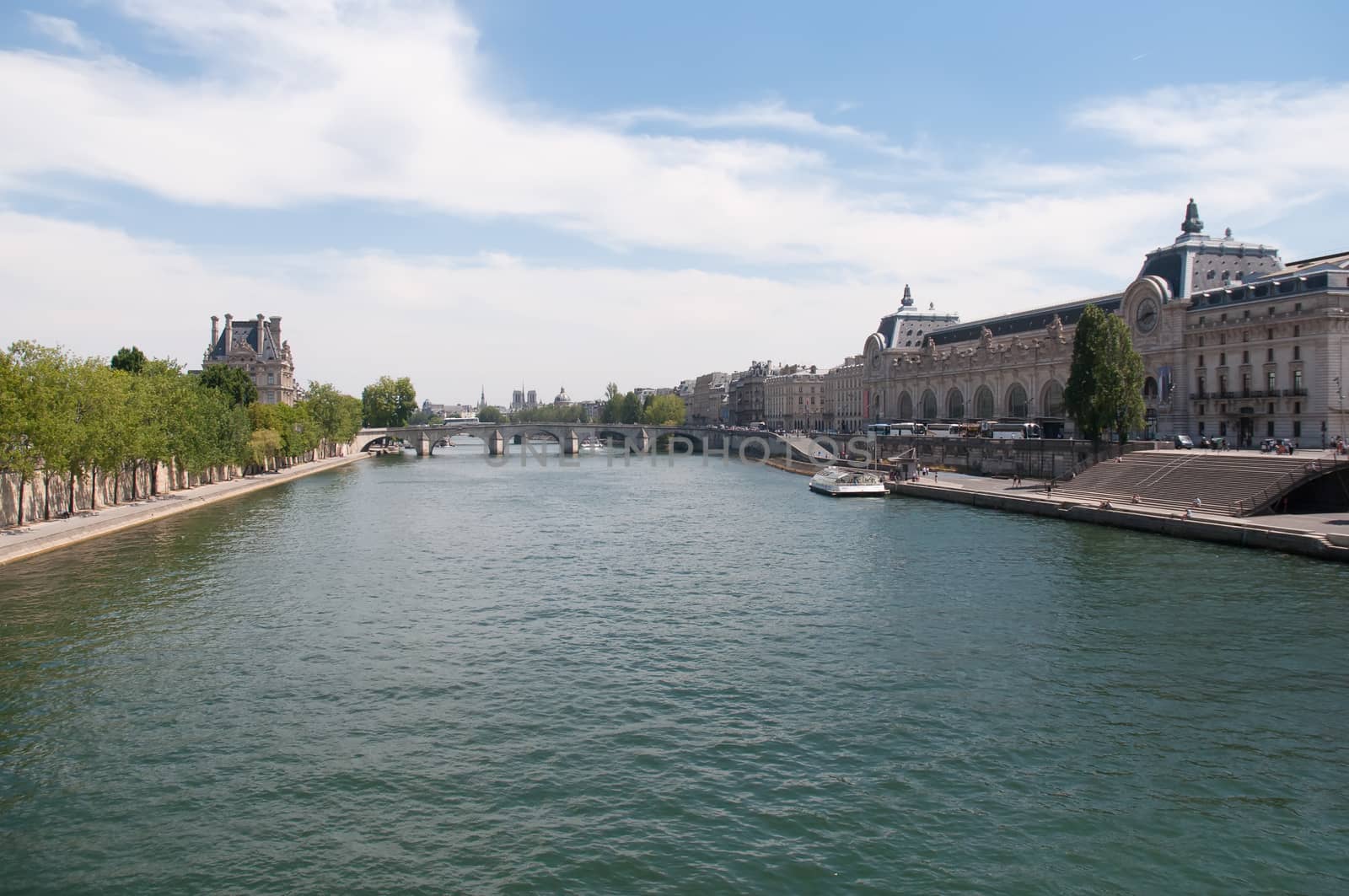 Louvre Museum exterior and Royal Bridge over the Seine river seen from Museum D'Orsay .