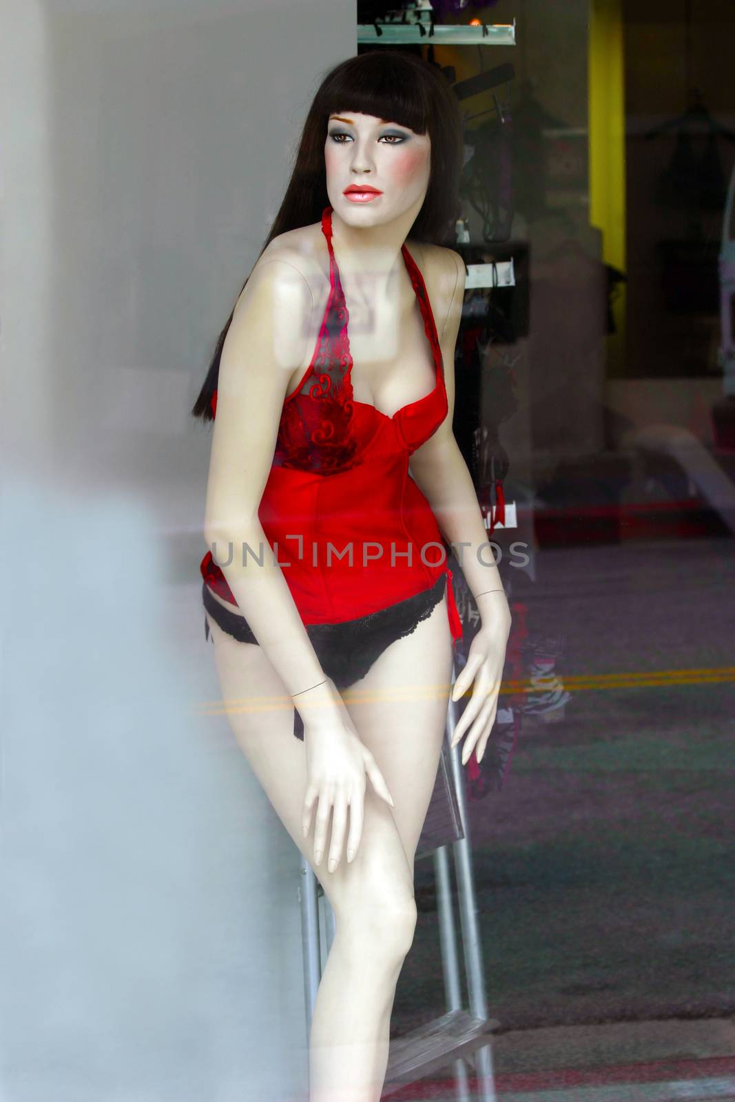 Female mannequin with sexy poses in a shop window