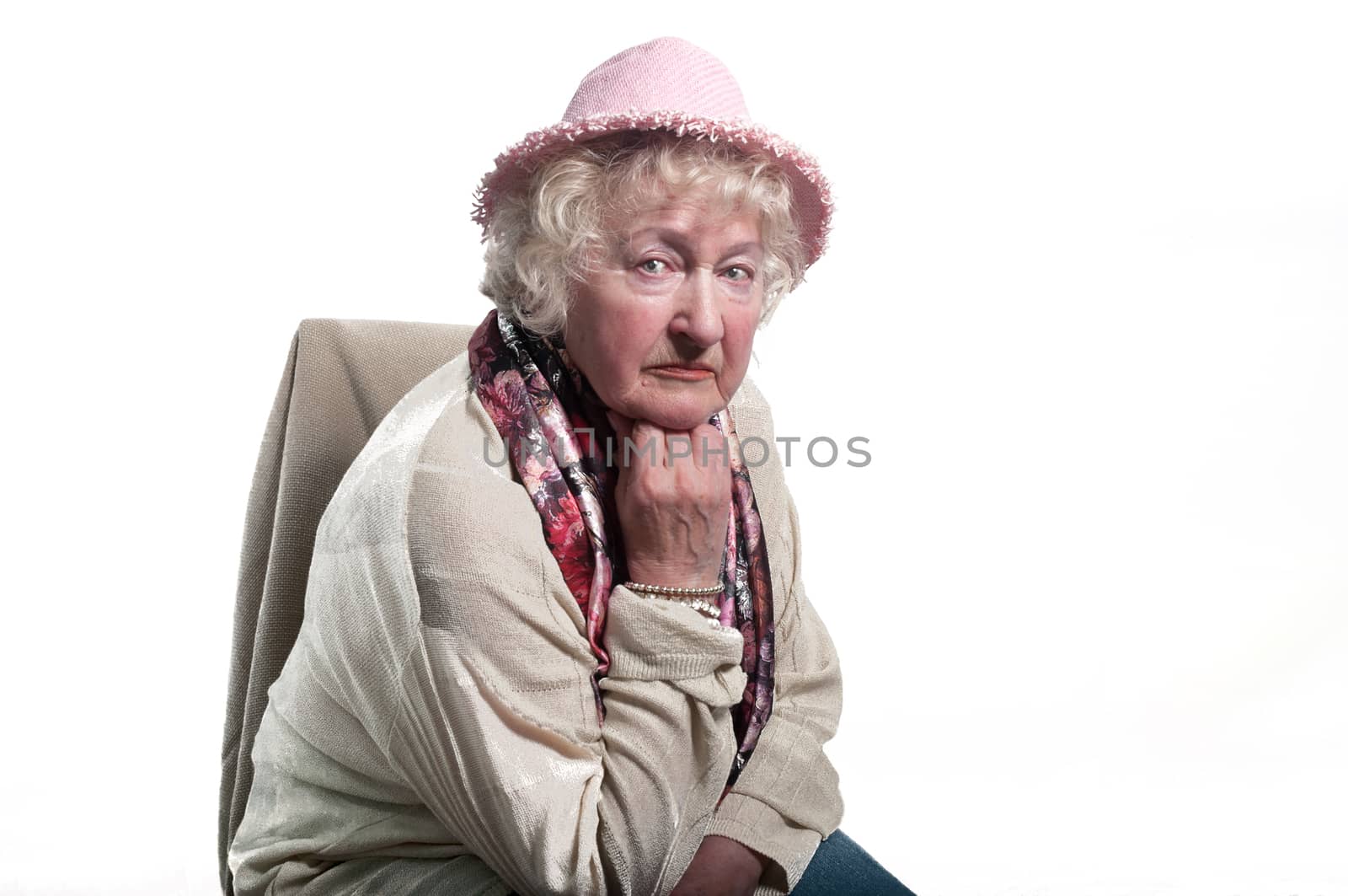 Portrait of  80 years old woman  in a hat .