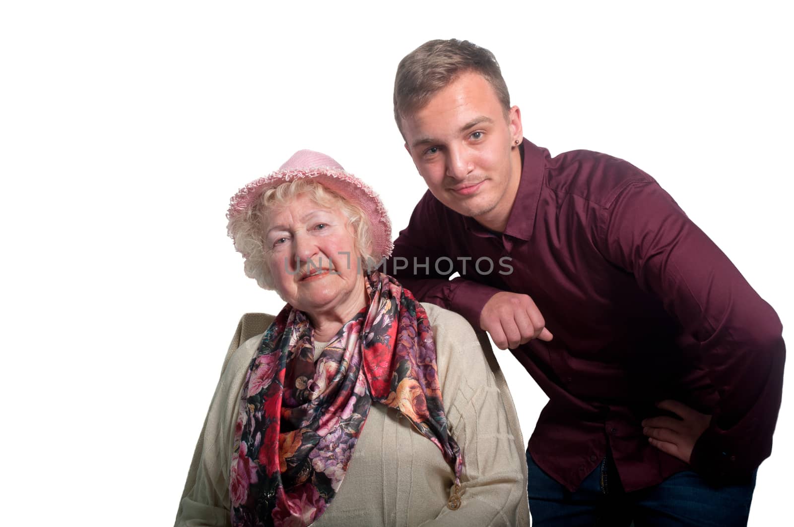 Grandmother in a pink hat and her grandson on a white background .