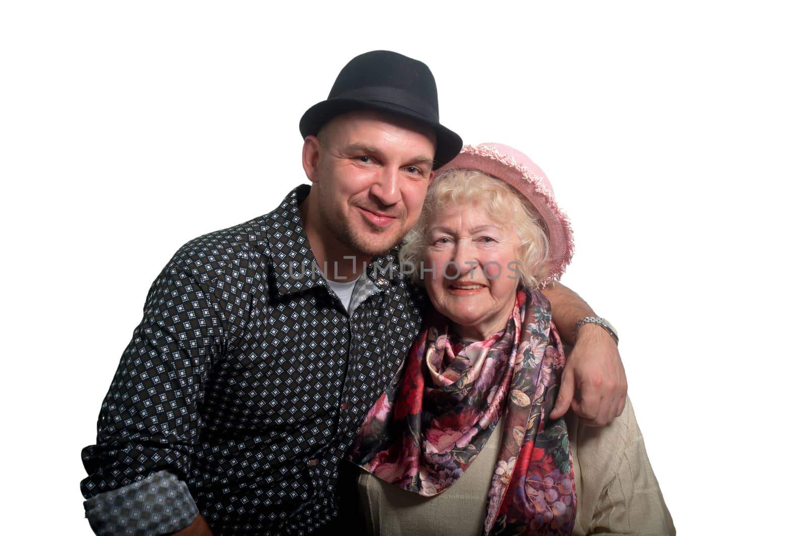 Grandmother in a pink hat and her grandson in a black  hat on a white background .
