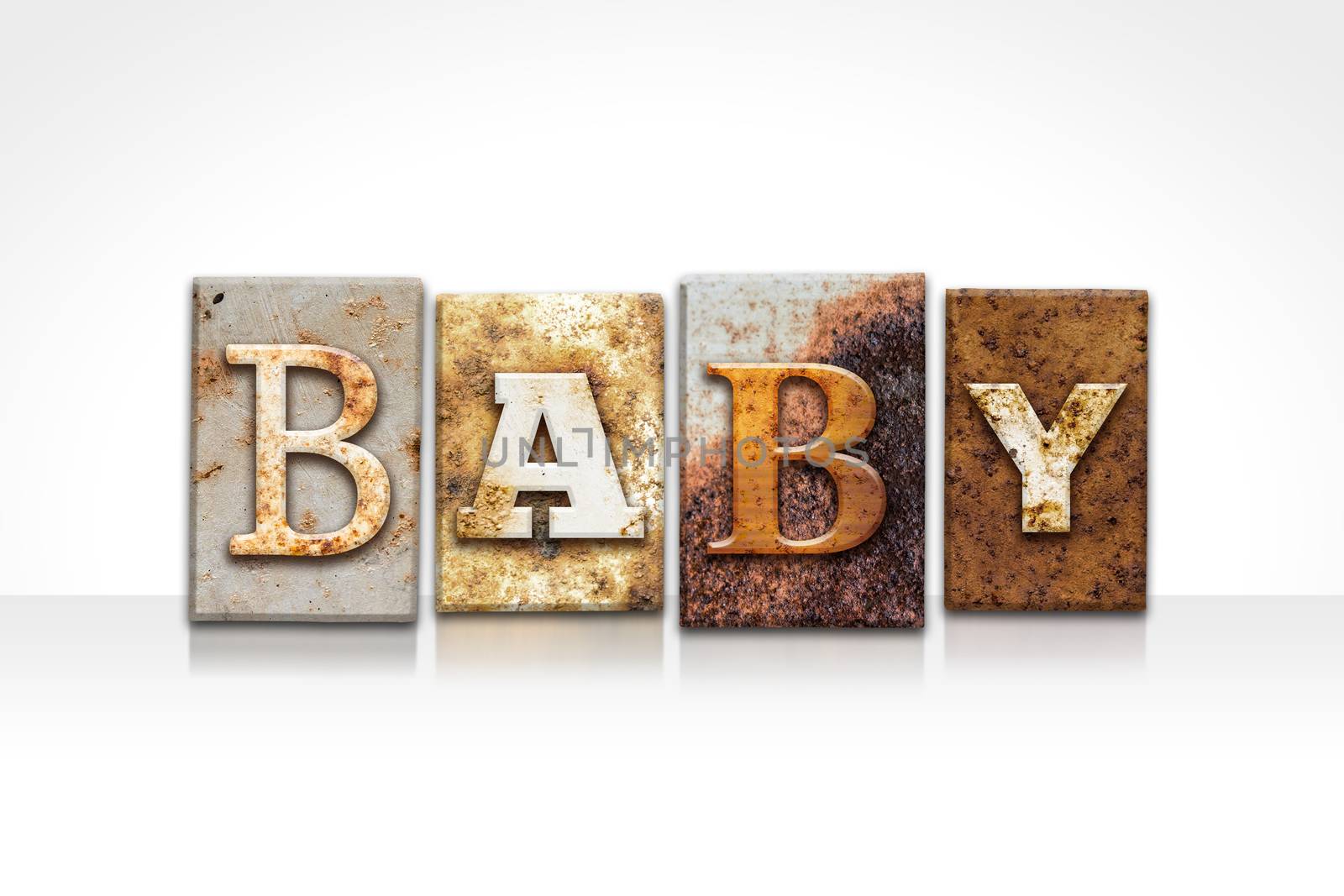 The word "BABY" written in rusty metal letterpress type isolated on a white background.