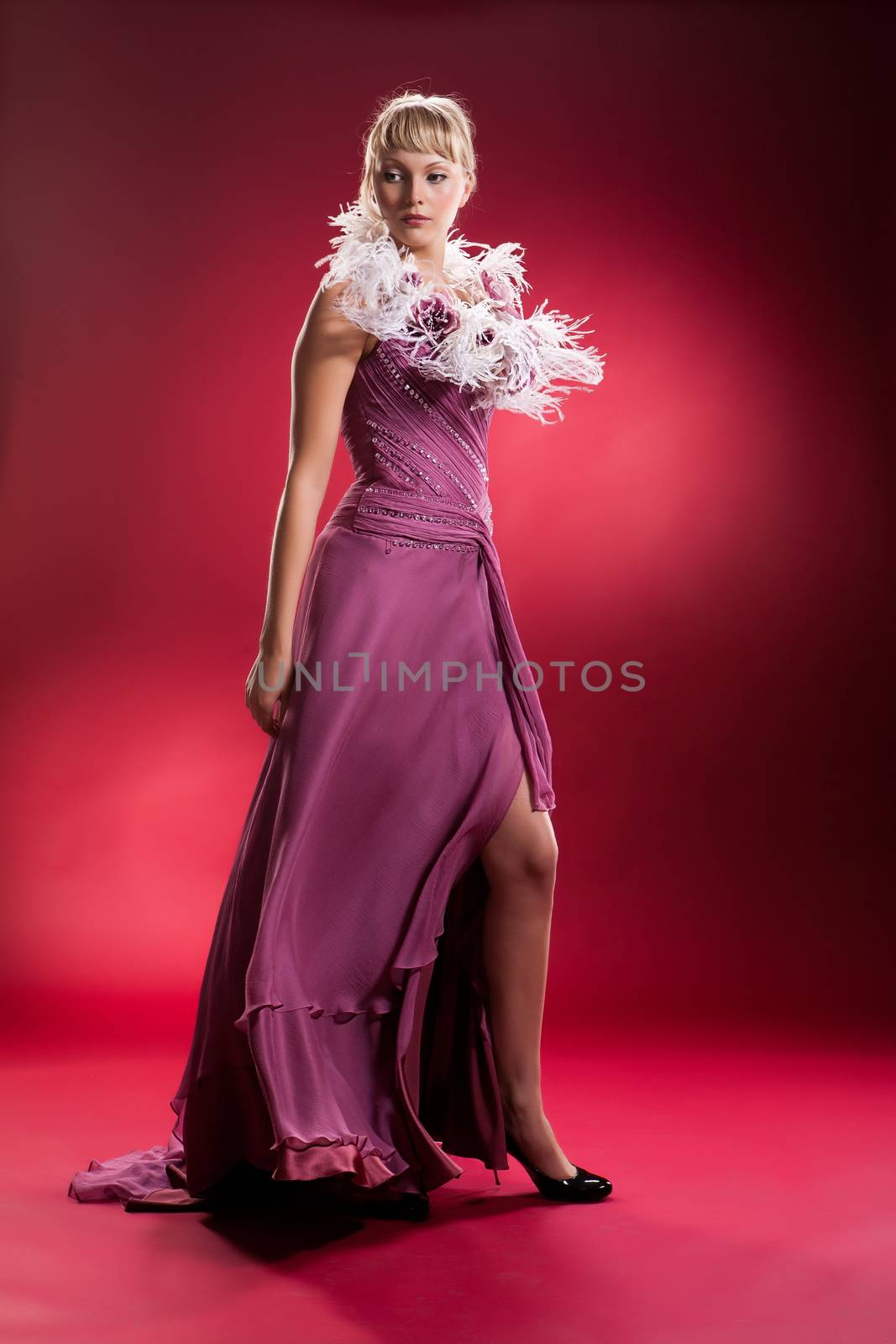 Young woman in a wedding dress on a studio background