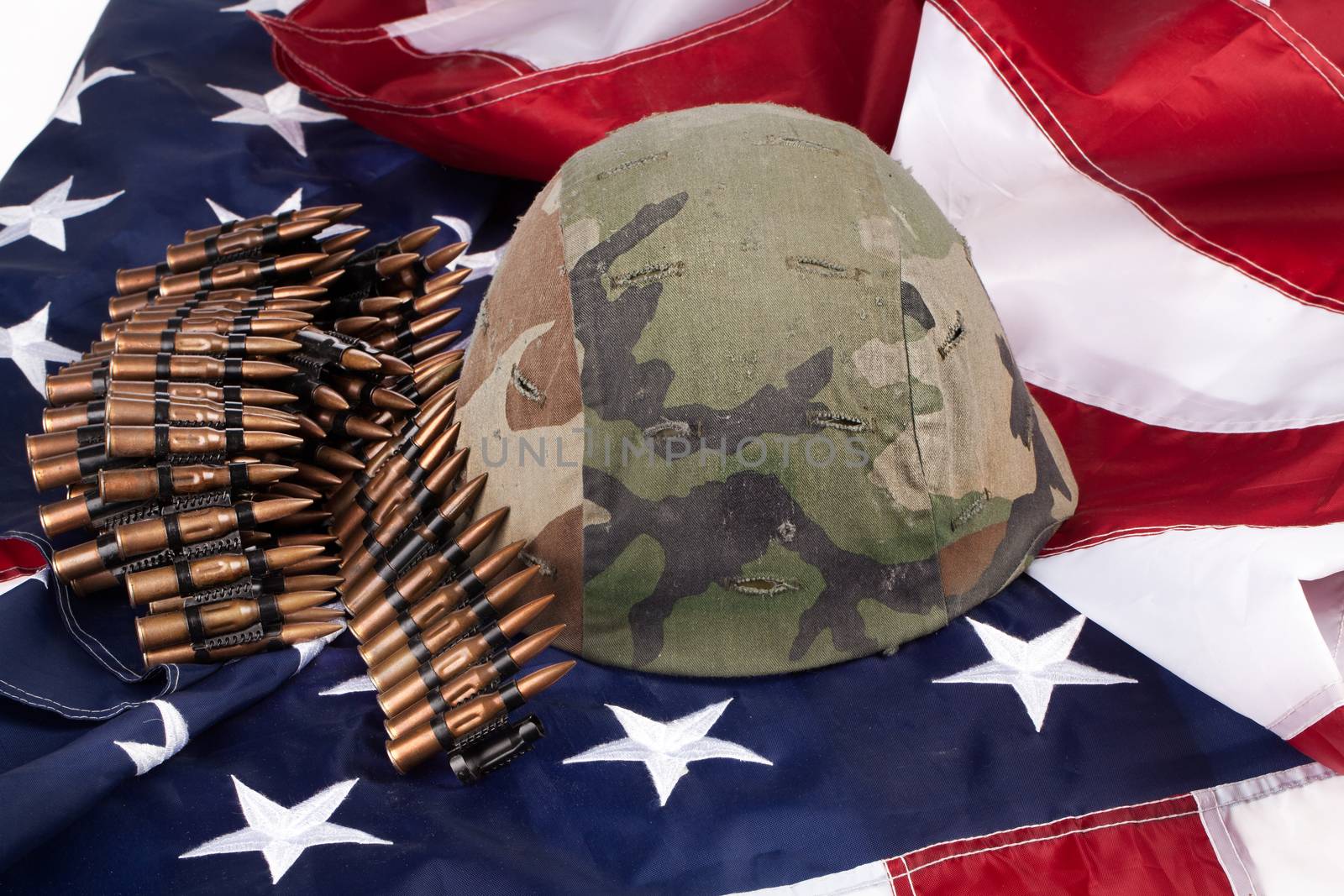 Band with cartdidges and army helmet on an american flag