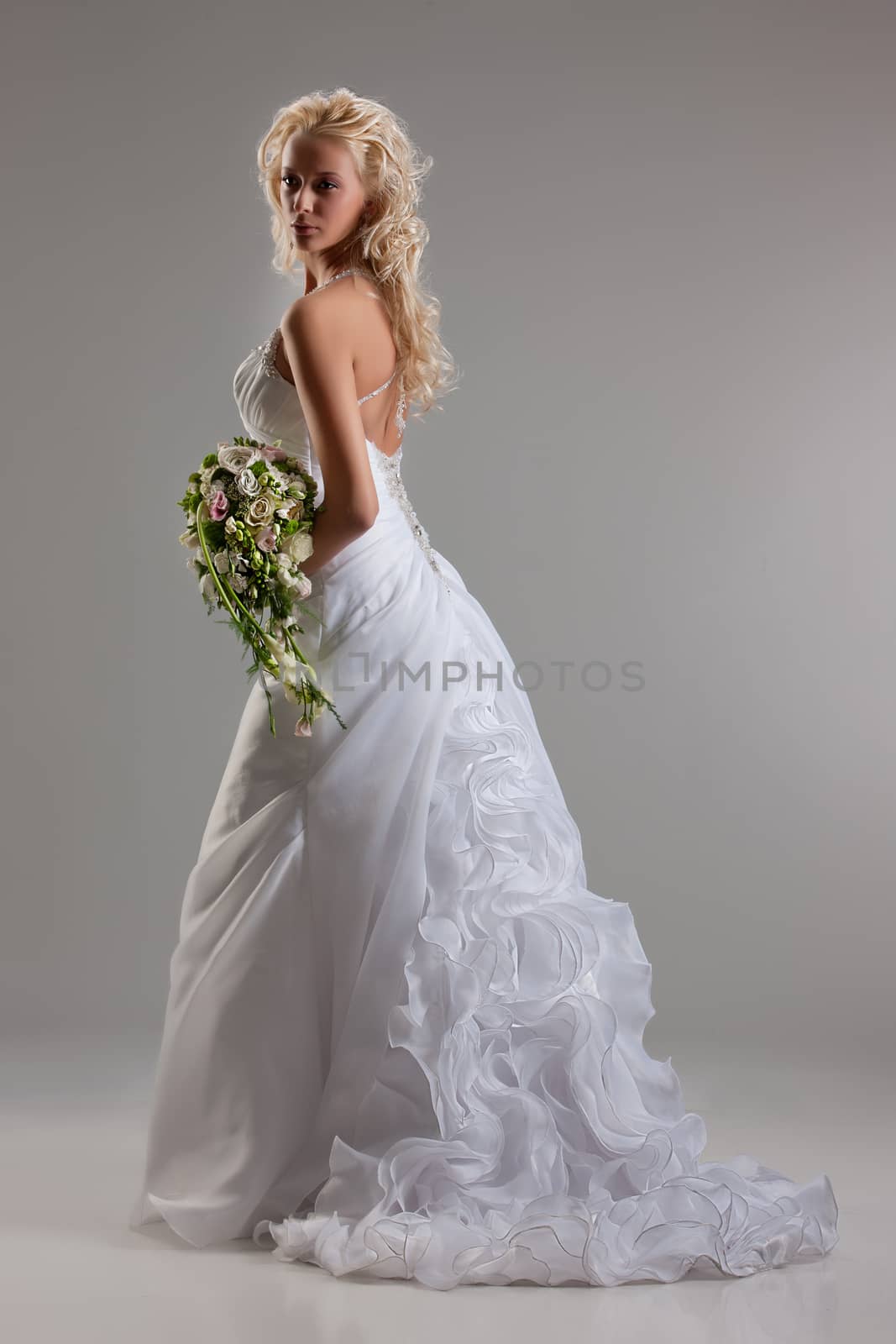 Young beautiful blonde woman in a fashionable wedding dress