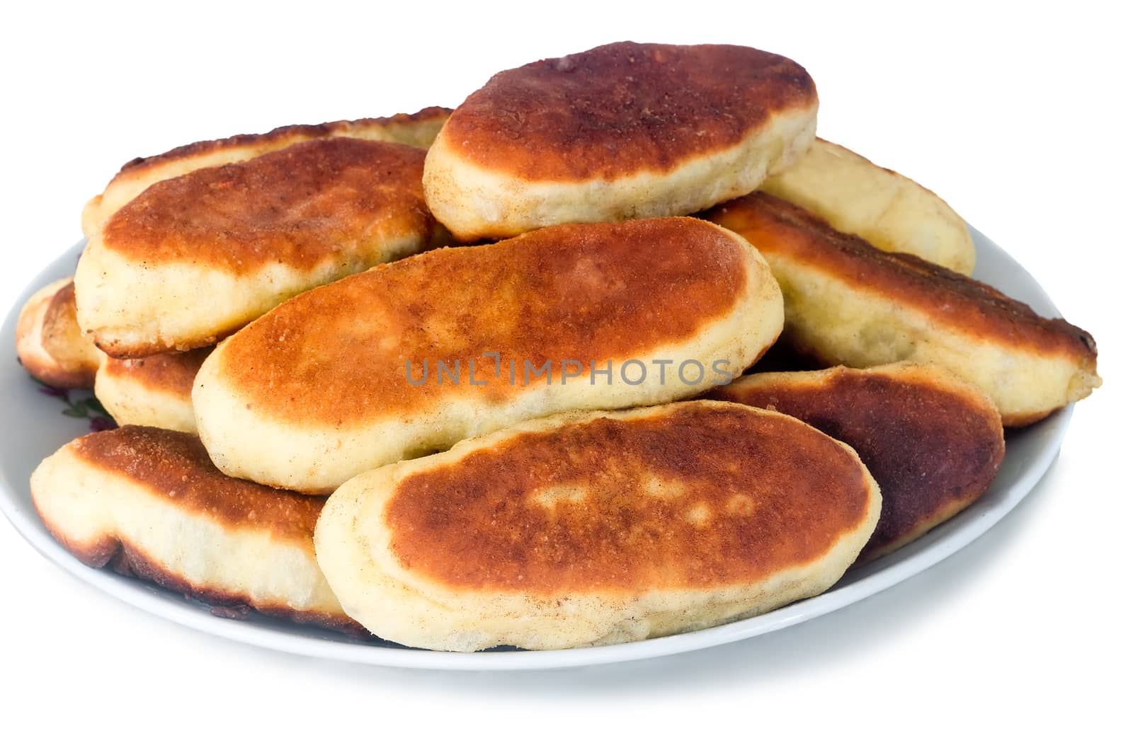 Mouth-watering freshly baked pies on a white ceramic dish. Presented on a white background.