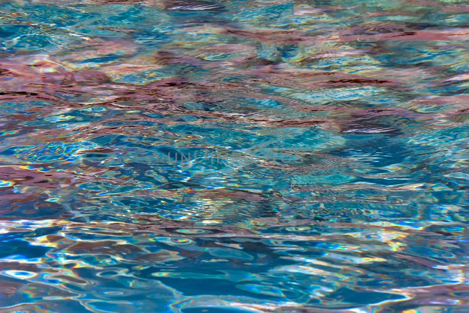 Shining colored light from the surface of the water in the pool. by georgina198