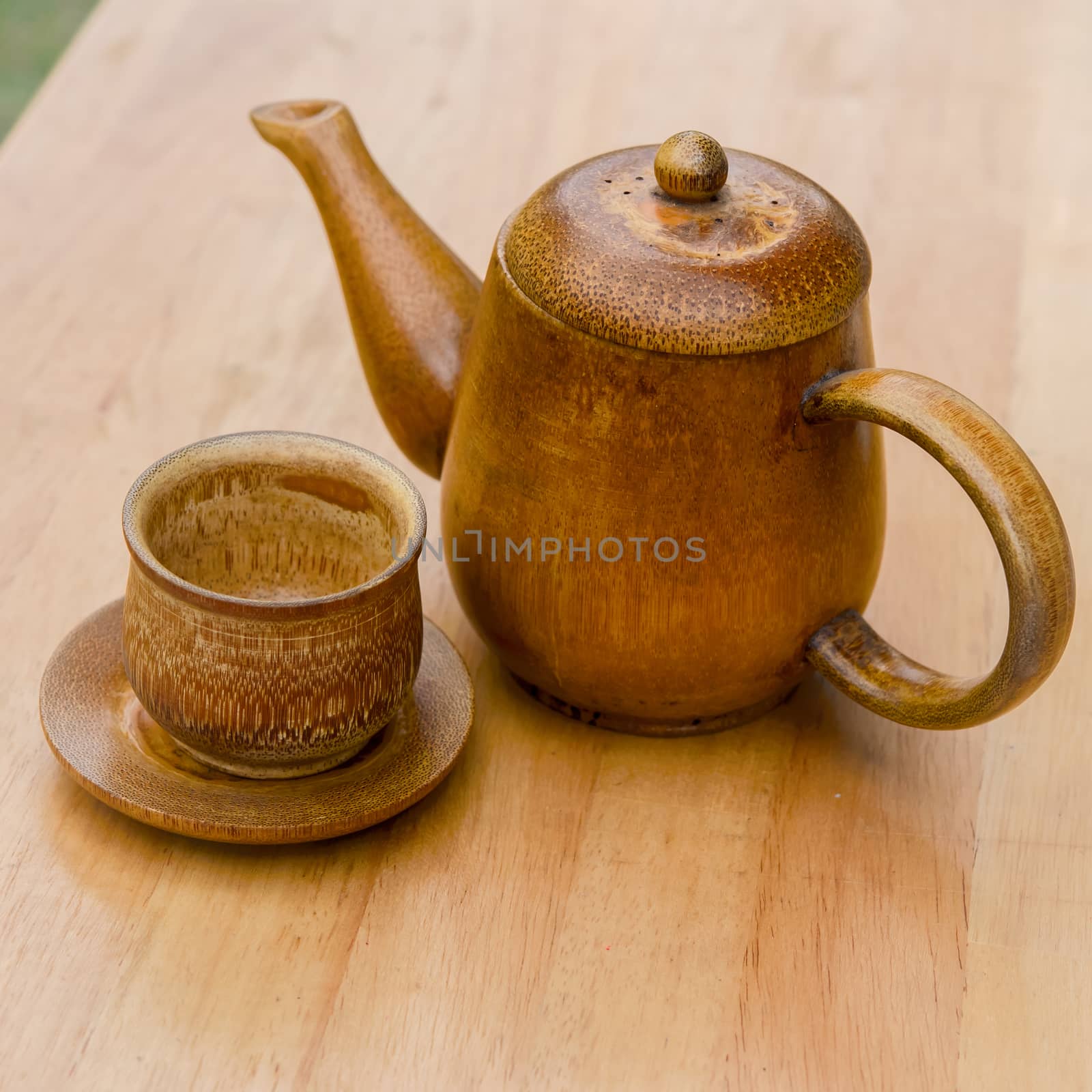 Cup of tea and teapot on wooden desk