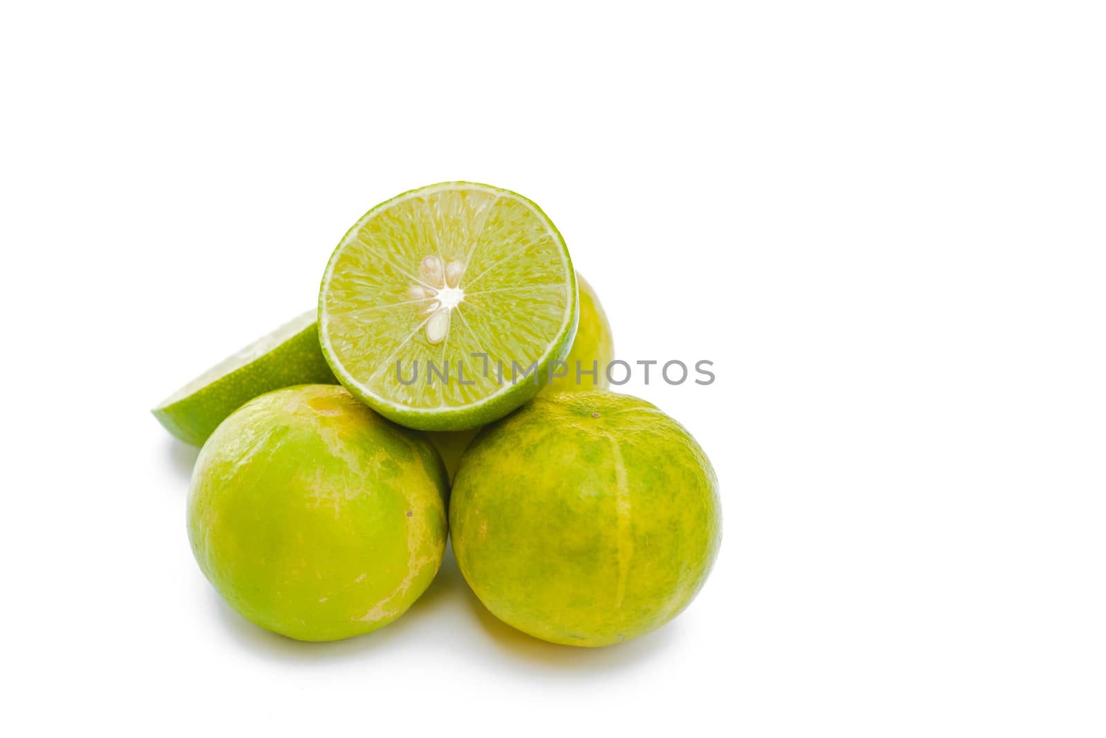 Juicy slices of lime isolated on white background.