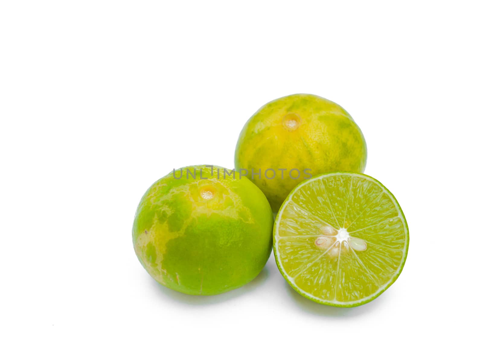 Juicy slices of lime isolated on white background.