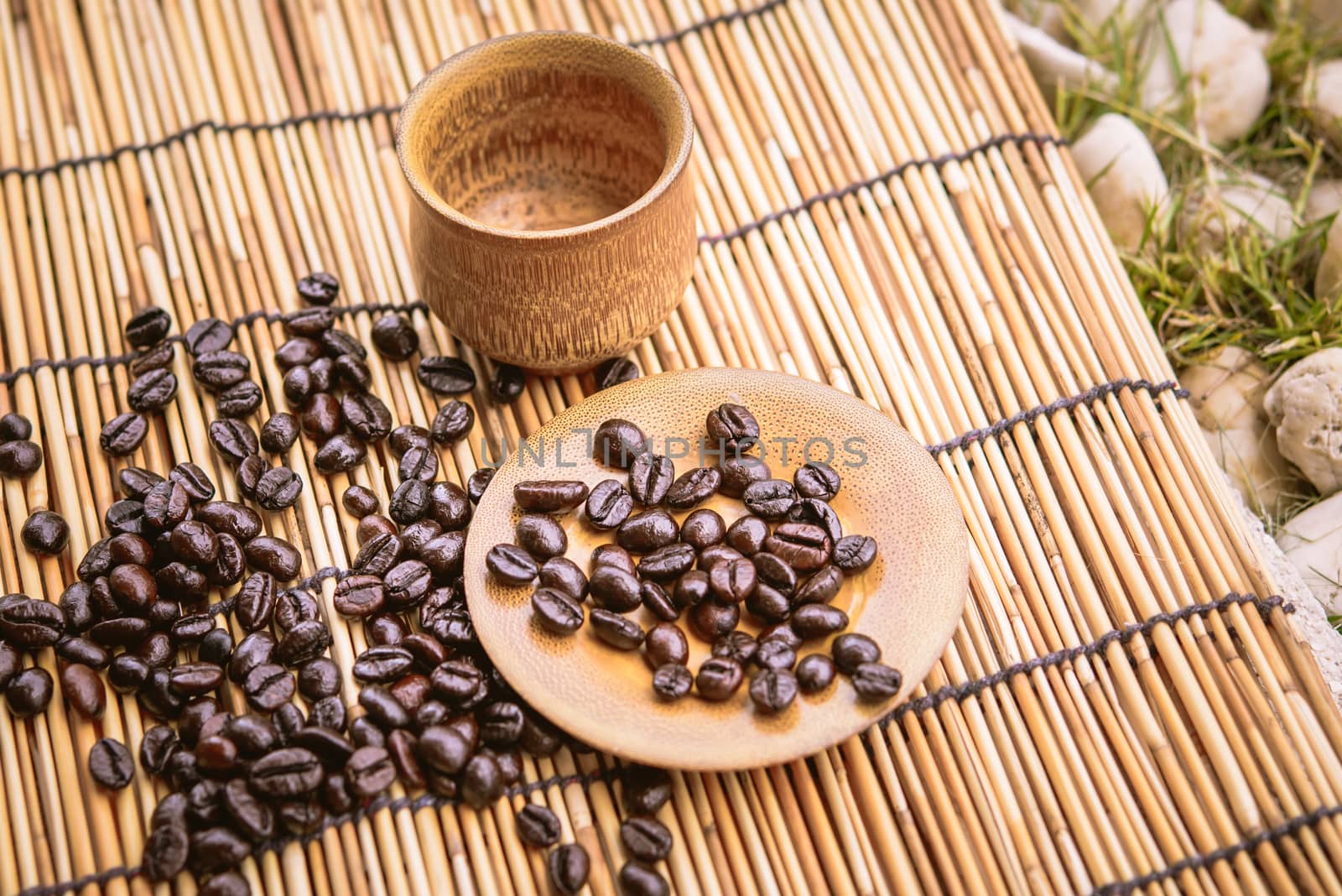 Photo in vintage color image style.Coffee beans and coffee cup set on bamboo wooden background.Soft focus.