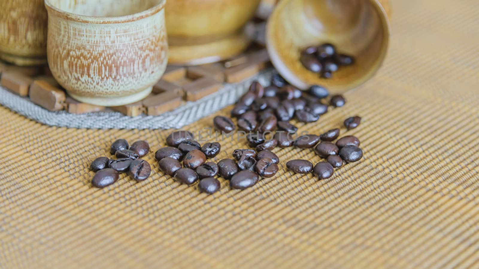 Soft focus image of coffee beans and coffee cups set on wooden background.Vintage style.(soft focus)