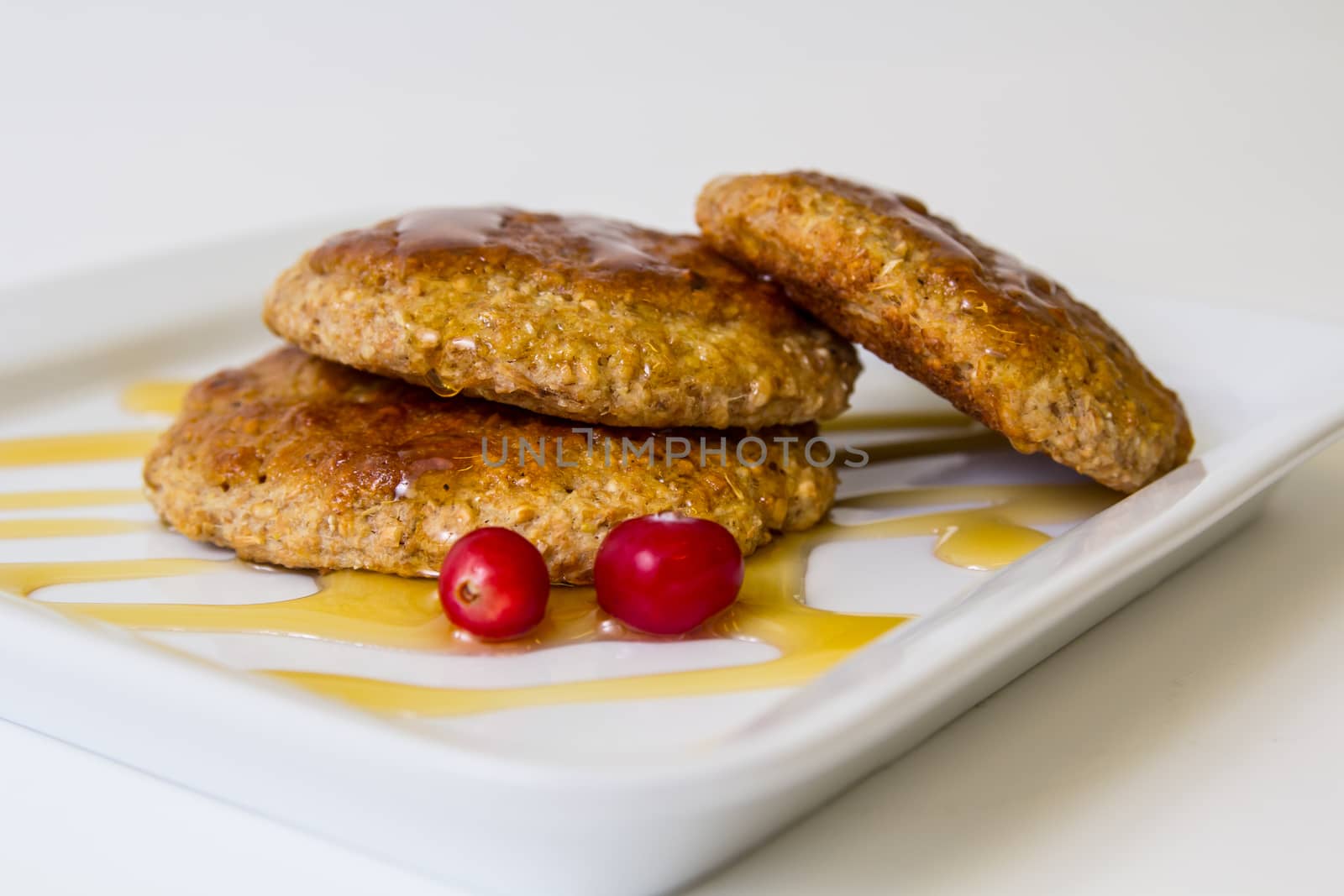 Oatmeal cookies topped with honey isolated on white