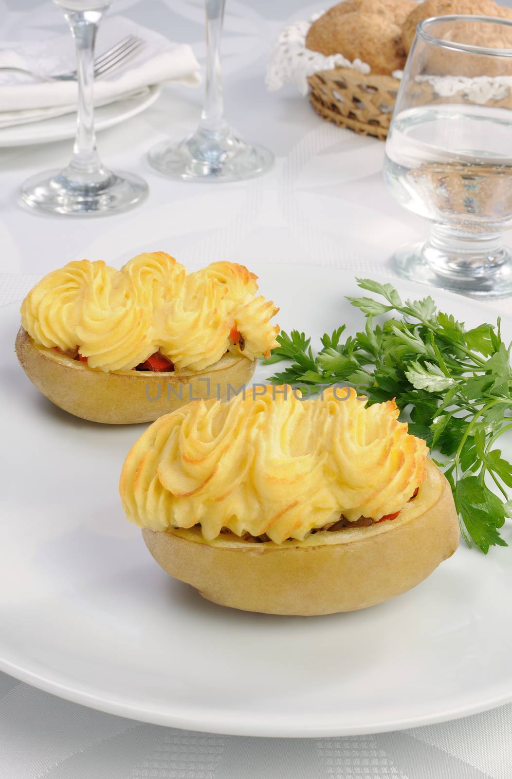 Baked potatoes stuffed with vegetables on a platter