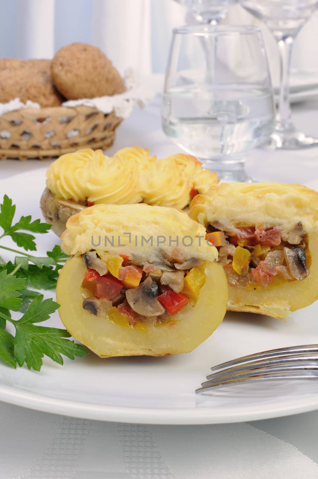 Baked potatoes stuffed with vegetables on a platter