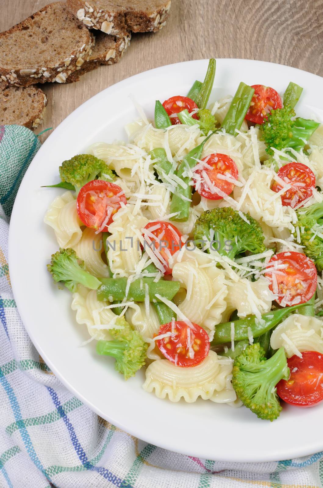 Pasta with broccoli, tomatoes, green beans and parmesan