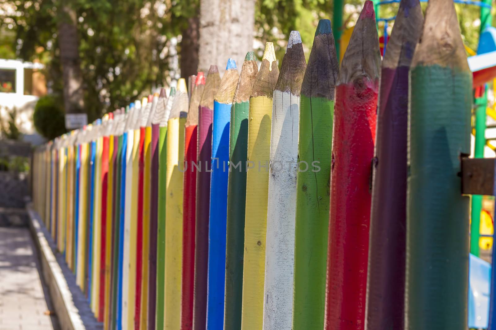 Fence of colourful pencils outside a preschool. Nice depth of field.