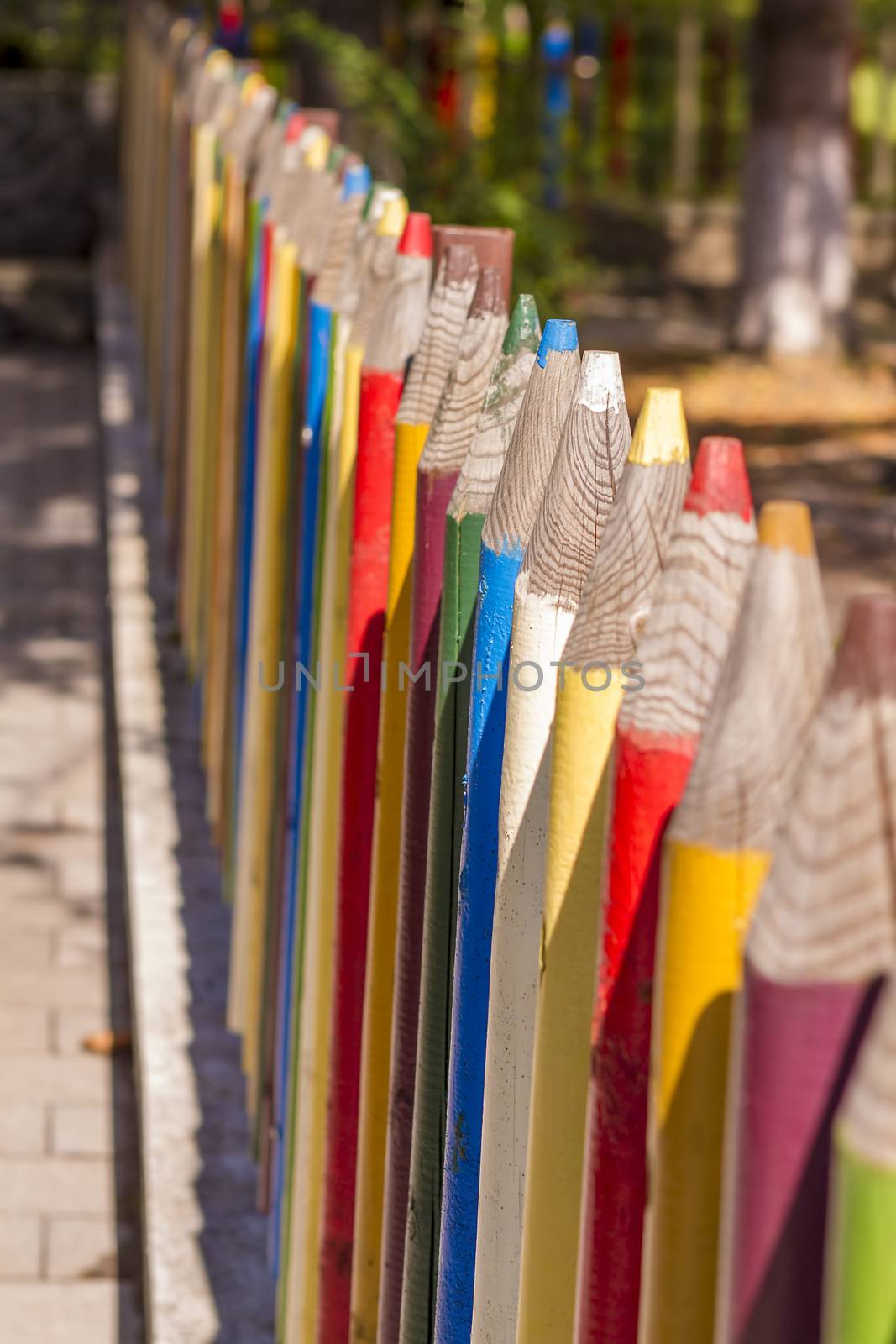 Fence of colourful pencils outside a preschool. Nice depth of field.